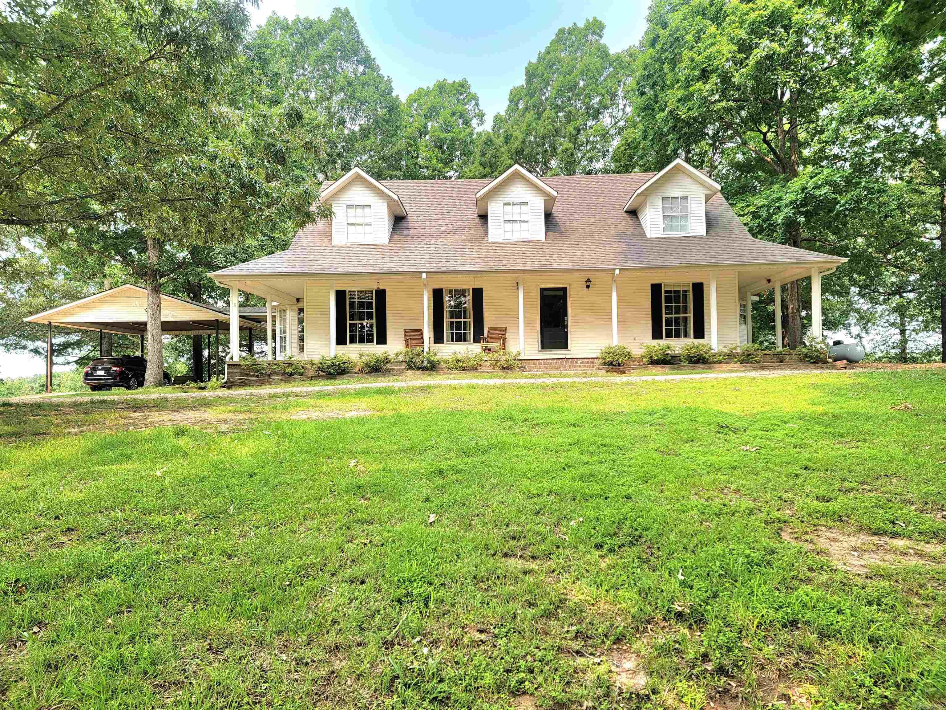 Discover the charm of country living with this exceptional 34 acre property, featuring gently rolling, fenced pastureland with some cross-fencing in place. Nestled at the end of a winding drive, the inviting white farmhouse offers classic Southern appeal with a wraparound porch and a full back deckāperfect for relaxing and taking in the scenic views. The home provides over 2,500 square feet of finished living space, plus an additional 1,328 square feet of unfinished basement, ideal for ample storage or the creation of a storm shelter or hobby space. A large pole barn offers excellent coverage for equipment, tools, or recreational vehicles. This property offers limitless potentialāwhether you're looking for a peaceful homestead, a hobby farm, or a recreational retreat. See Agents Comments