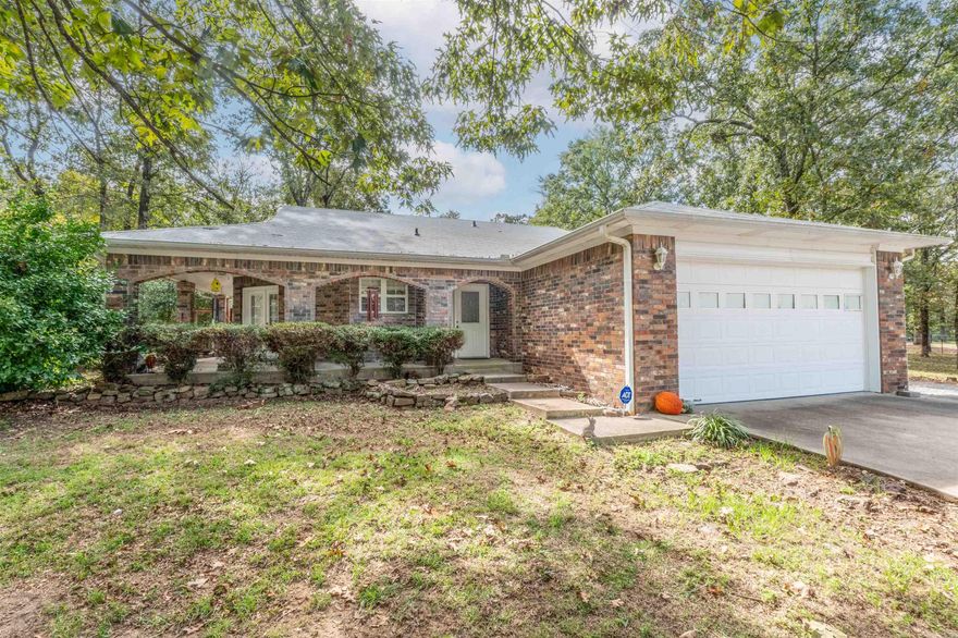 Welcome to your dream home in the heart of Greenbrier, Arkansas! This beautifully updated property offers the perfect blend of modern comfort and Southern charm. From the moment you arrive, you’ll fall in love with the incredible wraparound porch, ideal for morning coffee or evening relaxation.  Inside, you’ll find spacious rooms filled with natural light, a cozy wood-burning fireplace, and walk-in closets that provide ample storage throughout. The updated kitchen and baths, including a luxurious walk-in shower, ensure a move-in ready experience with no work required.  Step outside to enjoy a large covered patio, perfect for entertaining or unwinding. The tree-shaded lawn offers both beauty and privacy, creating a peaceful outdoor retreat.  Bonus alert: The property also features an additional detached three-car shop/garage complete with a full bathroom — an ideal setup for a man cave, hobby space, or even a potential ADU (Accessory Dwelling Unit) conversion for guests or multi-generational living.  Whether you're looking to settle into a forever home or find a tranquil escape with flexible space and modern updates, this property is a must-see!