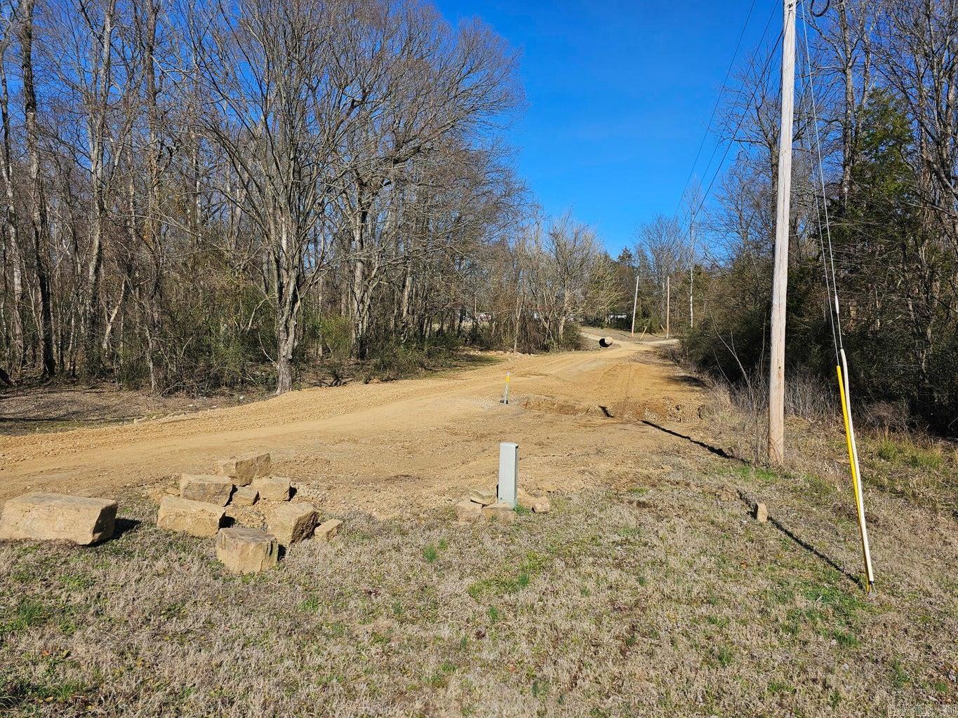 Almost 16 wooded acres ready for your vision. There is a good road that goes along the west boundary and the north boundary. There is a creek running across the western portion. There are several areas that would make nice home sites with some clearing. Very close to Cabin Creek Recreation Area and Arkansas River. The survey, topo map, and aerials are in the documents and pictures.