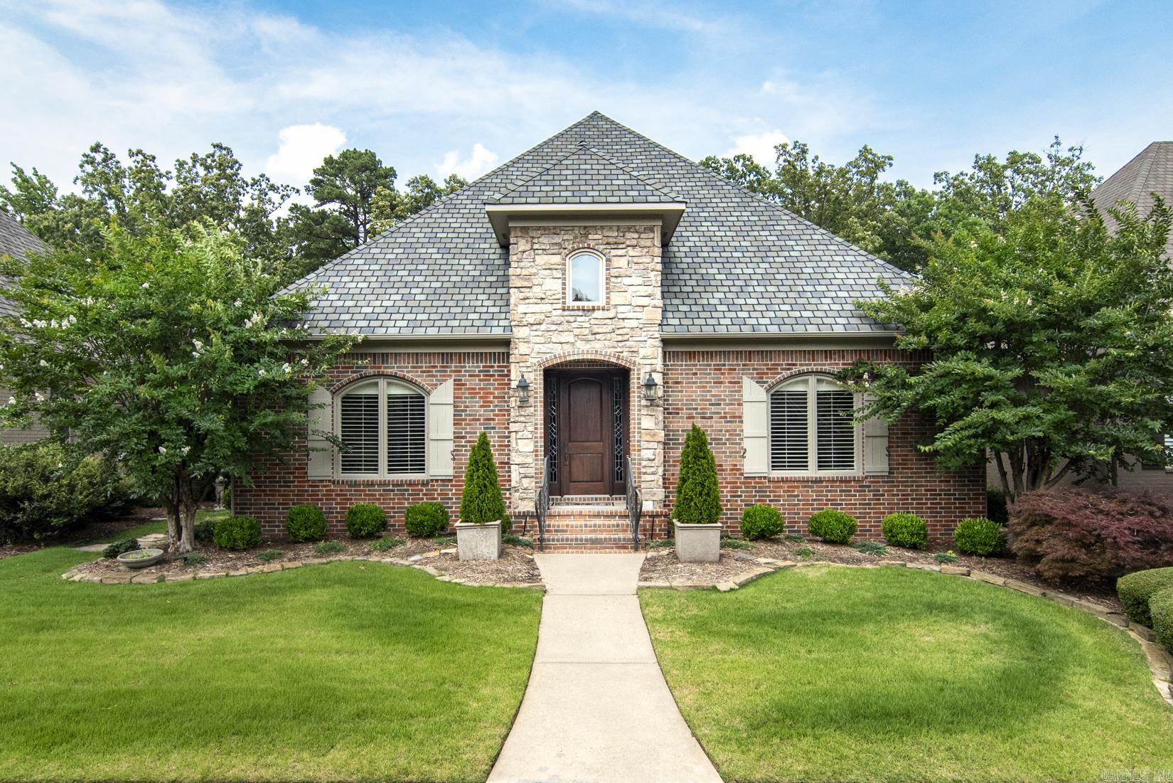 Well maintained one level home in the gated Oaks neighborhood of Chenal where lawns are maintained by the POA. The inviting foyer has slate floors and beautiful moldings. To the left is a Formal dining room with a butler's pantry with granite countertops and pretty cabinetry. Hardwood floors in the dining room, kitchen, breakfast area and great room. Abundant cabinetry with under counter lighting provides a great place for showcasing collectibles and china. Large primary suite with ensuite bath with walk-in shower, and walk-in closet with built-in cabinetry. There are 2 other bedrooms of which the front bedroom has had extensive wood cabinetry including desks and storage cabinets added in order to make a lovely office. Pretty light fixtures, recessed lighting, plantation shutters, security system, side veranda and walk up attic storage with rear load garage make this home a great place to live. Call today for a showing. Gate code required.