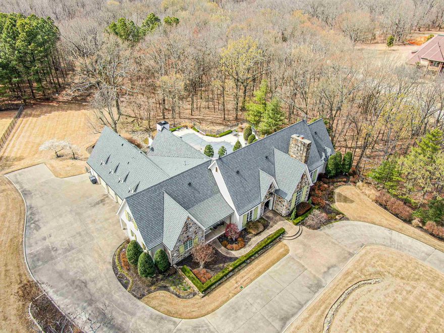 This expansive estate on 3.5 acres is breathtaking to say the least, this home exudes classic elegance and most of the impeccable furnishings will be included in the sales price, there is a formal living room, dining room, office with built ins, and an open foyer gallery. There are 5 large en-suite bedrooms, with the primary having a laundry center in the walk in closet and spa like bath with over sized tub and tiled spa shower, the main floor leads out to a soft-crete in-ground pool and patio for entertaining, the gourmet chef's kitchen including a viking gas stove overlooks a volume ceiling hearth room with wood beams, dining area, and breakfast bar, the walk out basement has a theatre room, wine bar, dining area with fireplace, Kitchenette, bedroom area and tons of storage, the upstairs has a large bonus room and two well appointed bedrooms with en-suite baths, there is a four car garage with side entry, circle drive and ample parking areas provided. The laundry has built ins and storage galore for all supplies. You must see this home.