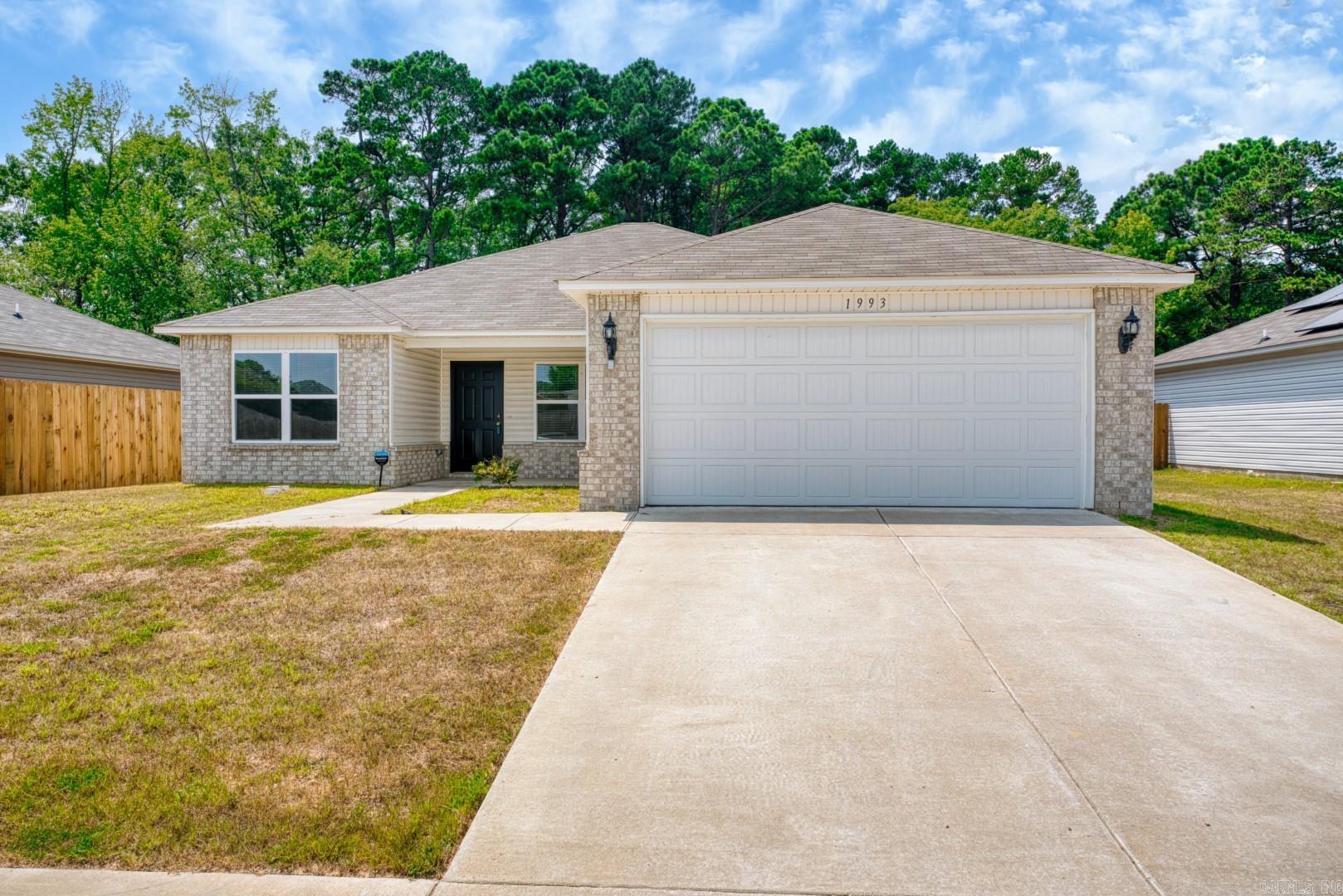 Welcome to 1993 Milburn Drive in Benton! Constructed in 2022 by Roush Coleman, this home offers modern comfort with its Lowell II floor plan. It features 3 bedrooms, 2 bathrooms, and a 2-car garage. The open-concept layout connects the living, dining, and kitchen areas seamlessly. The primary suite is on one side of the home, while the two guest rooms are on the opposite side for added privacy. The bedrooms have plush carpeting, and luxury vinyl plank flooring is used in the living areas, bathrooms, kitchen, and hallways. The kitchen includes stainless steel appliances: an electric smooth top range, dishwasher, microwave vented hood, and fridge. All new appliances and the Washer & Dryer, convey with the sale of the home. The fenced backyard provides security and privacy for outdoor gatherings.