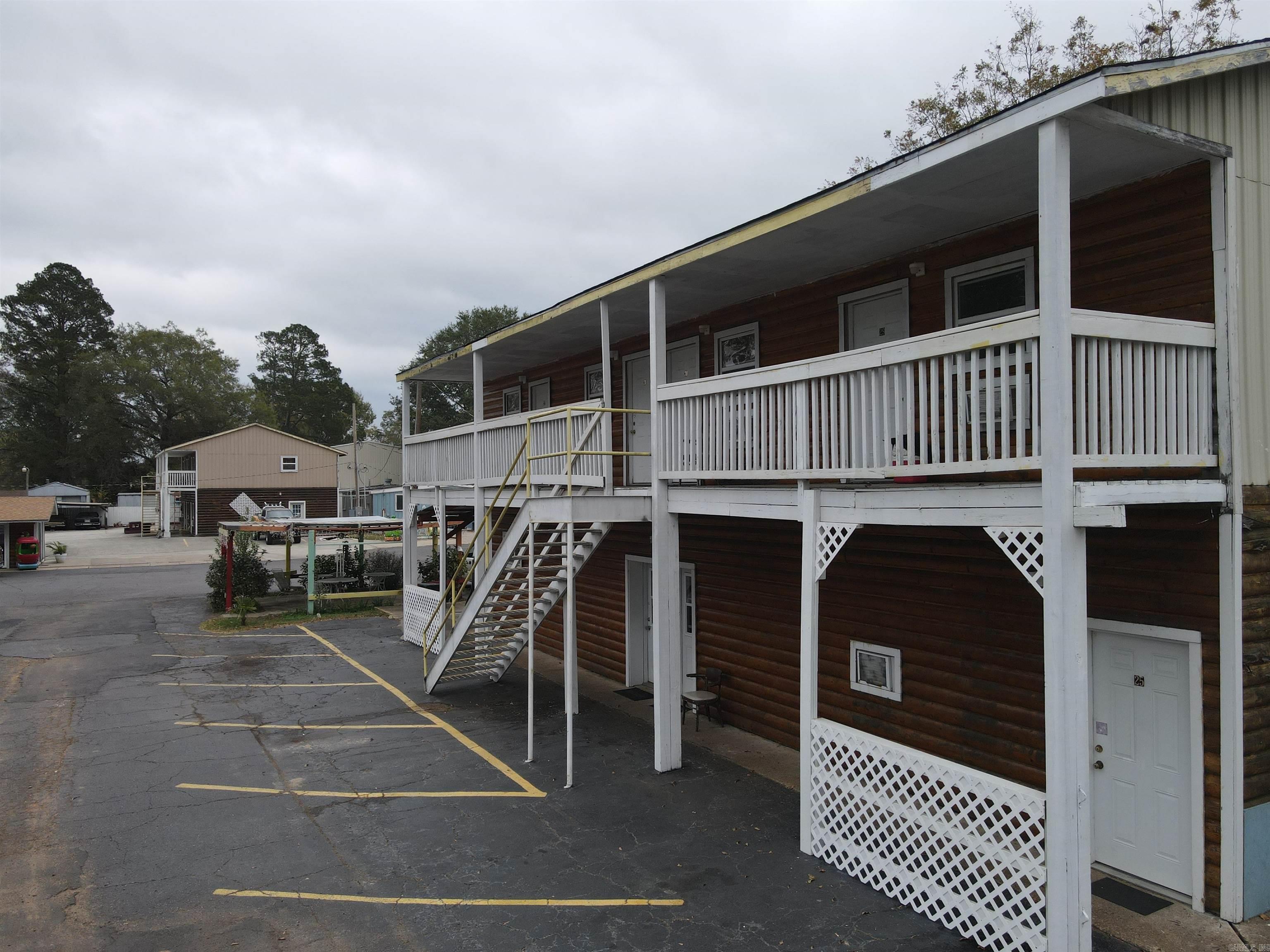 PRICE IMPROVEMENT!!! MOTIVATED SELLERS!!! Investors check this out!!!! United Country Red River Properties is excited to bring to market, The Little Shamrock Motel in Murfreesboro, Arkansas. The Shamrock is two fully fenced city blocks and features five buildings, with a total of thirty units and six more currently being under construction. The motel comes furnished and includes a breakfast room with guest laundry area, office, manager suite, large laundry area for the motel linens, a 1500 +/- square foot house that adjoins the manager suite and office, as well as a pool/waterpark area that houses a 32ft inground swimming pool and water features. These include slides and a wet area in the back half of the building. All of which is perfect for your guests to cool off and relax after a long day of digging for diamonds at the Crater of Diamonds State Park located just minutes down the road. Don't miss this one!!
