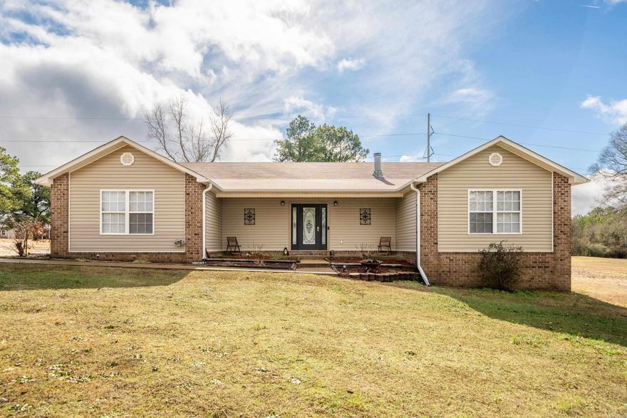 Charming Country Home on 2.17 Acres. This Home features a split floor plan, 3 Bedrooms and 2 bathrooms and an office or 4th bedroom. Master bedroom has a full bath, Walk-in shower and jacuzzi tub. Walk-in Closet. 4th bedroom or Office on one side.  Open living room with vaulted ceiling and a fireplace, kitchen /dining adjoining the open Livingroom. 2 and 3 bedrooms share a large jack and jill bathroom.  Laundry room off Hallway. Outside, a detached 2-car garage with openers provides ample space for vehicles or storage, connected to the main house by a covered breezeway that doubles as a relaxing back porch. Lot is level and cleared. livestock allowed.  Storage building. Experience the best of country living.