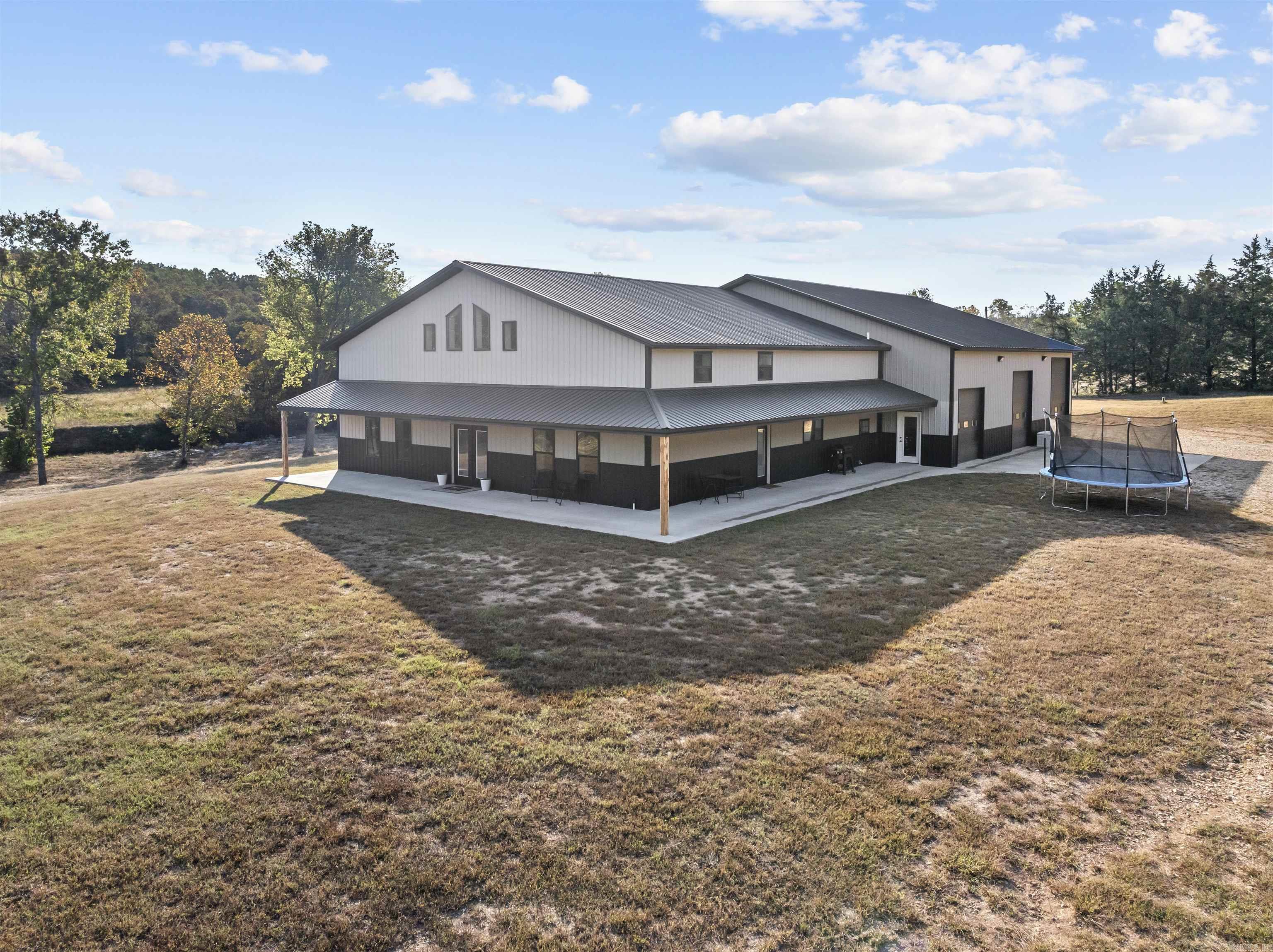 Welcome to your dream home! Built in 2023, this stunning barndominium offers nearly 4,000 sqft of living space, attached to a 3,600 sqft shop, blending modern luxury & country charm. The 4-bedroom, 3-bathroom home boasts an open floorplan with a cozy fireplace, custom kitchen featuring quartz countertops, high-end cabinetry, a walk-in pantry, & a large island for meal prep & casual dining. The primary bedroom is conveniently located on the main floor with its own en-suite bath. Set on 25 flat, cleared acres along West Sugarloaf Creek, this property offers peace & quiet, away from the hustle & bustle. Located less than 10 miles from a Bull Shoals Lake boat ramp, itās ideal for nature lovers. Sellers would consider selli