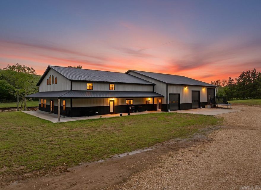 This 2023 custom barndominium offers nearly 4,000 sqft of open living space with a 3,600 sqft attached shop—perfect for those who want to live, work, & play without ever leaving home.  Inside, soaring ceilings & natural light make every space feel wide open. The kitchen is the heart of the home with quartz counters, a massive island, & a walk-in pantry that keeps life effortless. Four bedrooms & three full baths give everyone their own retreat, while the primary suite feels like a private spa.  Working from home is easy—the open layout provides space for an office, & the oversized shop adds room for business, hobbies, or big projects.  Beyond the walls, 25 level acres border West Sugarloaf Creek. Swim on hot afternoons, gather around a firepit, or cultivate your own homestead with cleared ground ready for gardens, livestock, or wide-open play.  Energy-efficient construction keeps life comfortable year-round, & when adventure calls, Bull Shoals Lake is just minutes away. Privacy, convenience, & freedom—all in one address.
