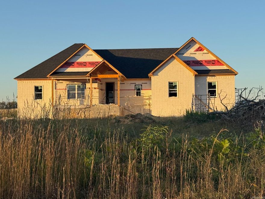 Beautiful New Construction featuring 4 bedrooms and 2.5 bathrooms. This open-concept floor plan makes excellent use of every square foot. The spacious kitchen includes a large island, and the living area offers a cozy fireplace. The laundry room features a locker-style drop zone, and the closets come with built-ins for added organization. Enjoy outdoor living on the covered back porch, perfect for entertaining. The home also includes a partially floored attic for extra storage. All of this sits on approximately one acre. Taxes are estimated on the lot only. This is a must-see!