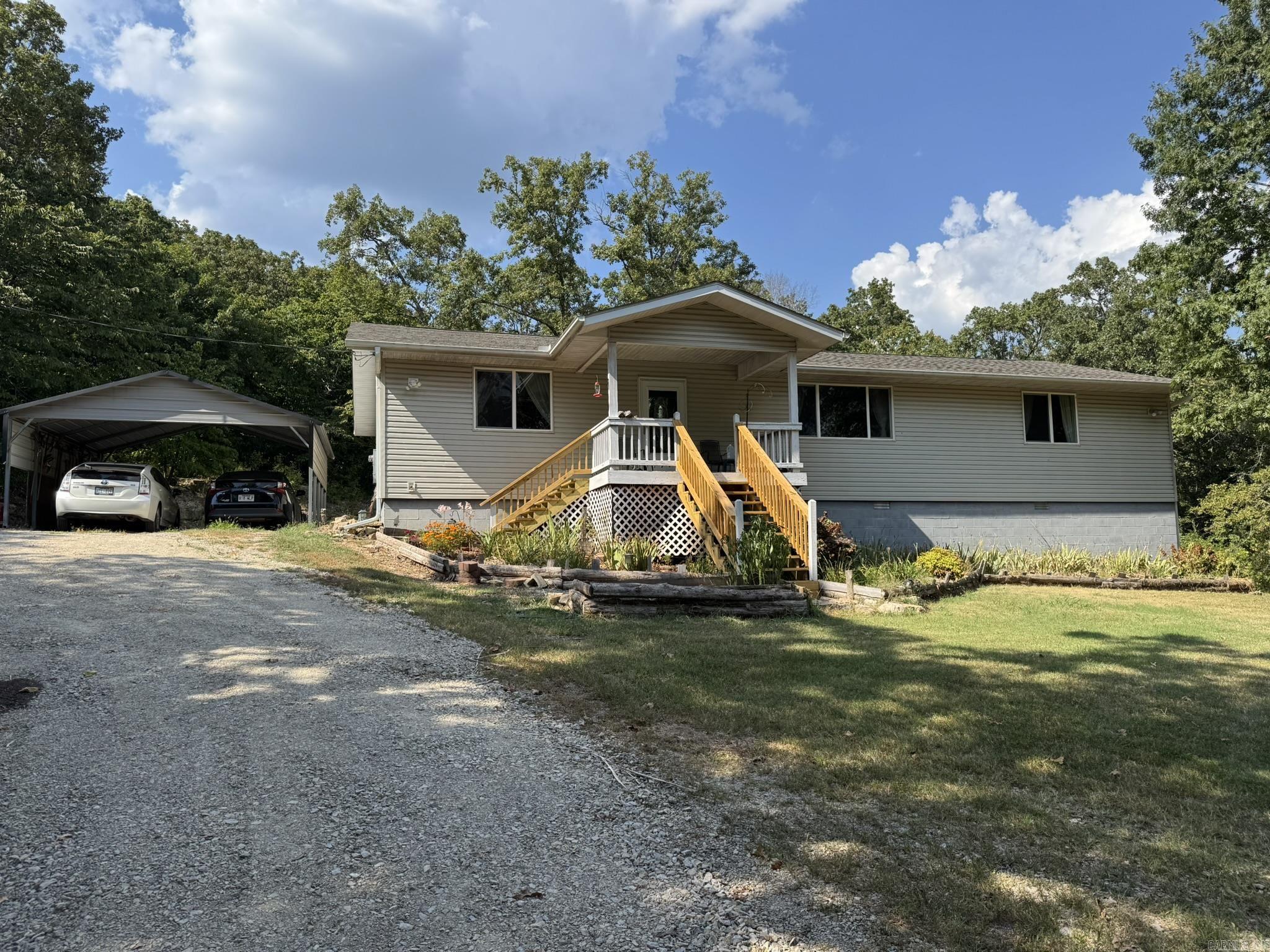 SECLUSION, PRIVACY, AND A NATURE LOVERS DREAM BEST DESCRIBES THIS WONDERFUL COUNTRY PROPERTY. THIS 3 BEDROOM/ 2 BATH HOME SITTING ON ALMOST 13 AC/ML FEATURES A SPLIT BEDROOM PLAN, WELL DESIGNED KITCHEN, DINING AREA, AND A SPACIOUS LAUNDRY ROOM, PLUS WALK IN CLOSETS IN EVERY BEDROOM. ENJOY A WOODED COUNTRY VIEW FROM THE COVERED FRONT PORCH, OR THE ROCK FEATURES AND RAISED GARDENS FROM THE BACK SCREENED IN COVERED DECK. OUTSIDE, TWO 2-CAR CARPORTS, A STORAGE SHED, AND A GREENHOUSE. RECENT UPDATES HAVE BEEN MADE TO THE FRONT & SIDE STAIRS, PLUS THE STAIRS OF THE BACK DECK. THE HOME SITS WELL BACK FROM THE COUNTY ROAD, OFFERING PLENTY OF PRIVACY. CENTRALLY LOCATED BETWEEN BULL SHOALS LAKE AND NORFORK LAKE ACCESS. MINUTES FROM WHITE RIVER ACCESS.
