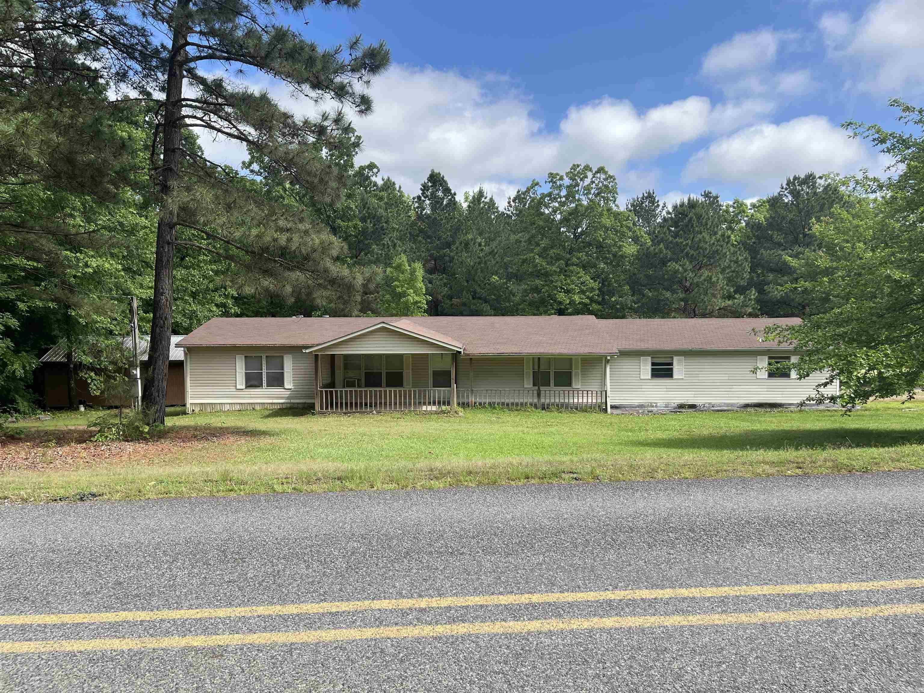 Inviting 3-bedroom, 2-bath manufactured home with an attached 2-car garage, situated on 1.5± acres. This property offers a spacious interior, a deck ideal for outdoor relaxation, a large shop for hobbies or storage, and an additional outdoor storage building. With plenty of room inside and out, this property provides endless possibilities—definitely a must-see!