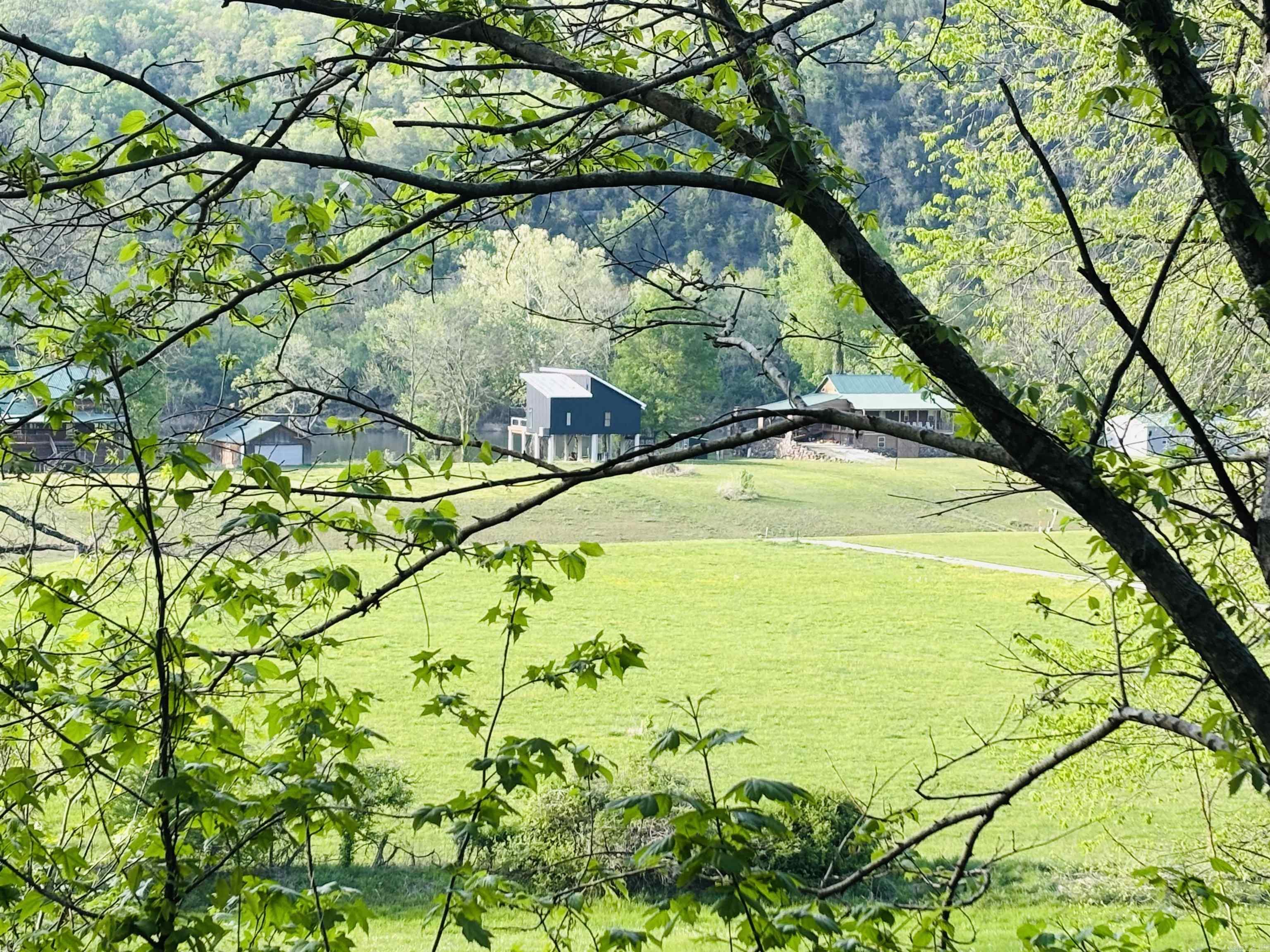 Gorgeous Tier II residential lot in White River's quiet peaceful Round Bottom Pool Estates just a few minutes from the shops, eateries, and music in beautiful Downtown Mountain View. This cleared and mow-able lot is ready to construct your dream home or vacation getaway (900 sq ft min) with power, public water, and Fiber availability right onsite. The mountain, bluff, and water views are nothing less than spectacular! This River Valley location offers some of the best fishing on White River plus has a ARGF Public Access boat launch for quick and easy river access. Lots in this subdivision rarely come available! Seller has 2 additional adjoining lots also for sale for a possible aggregate of over 2 or 3 gorgeous acres! Bill of Assurance. No mobile homes. Private septic required.