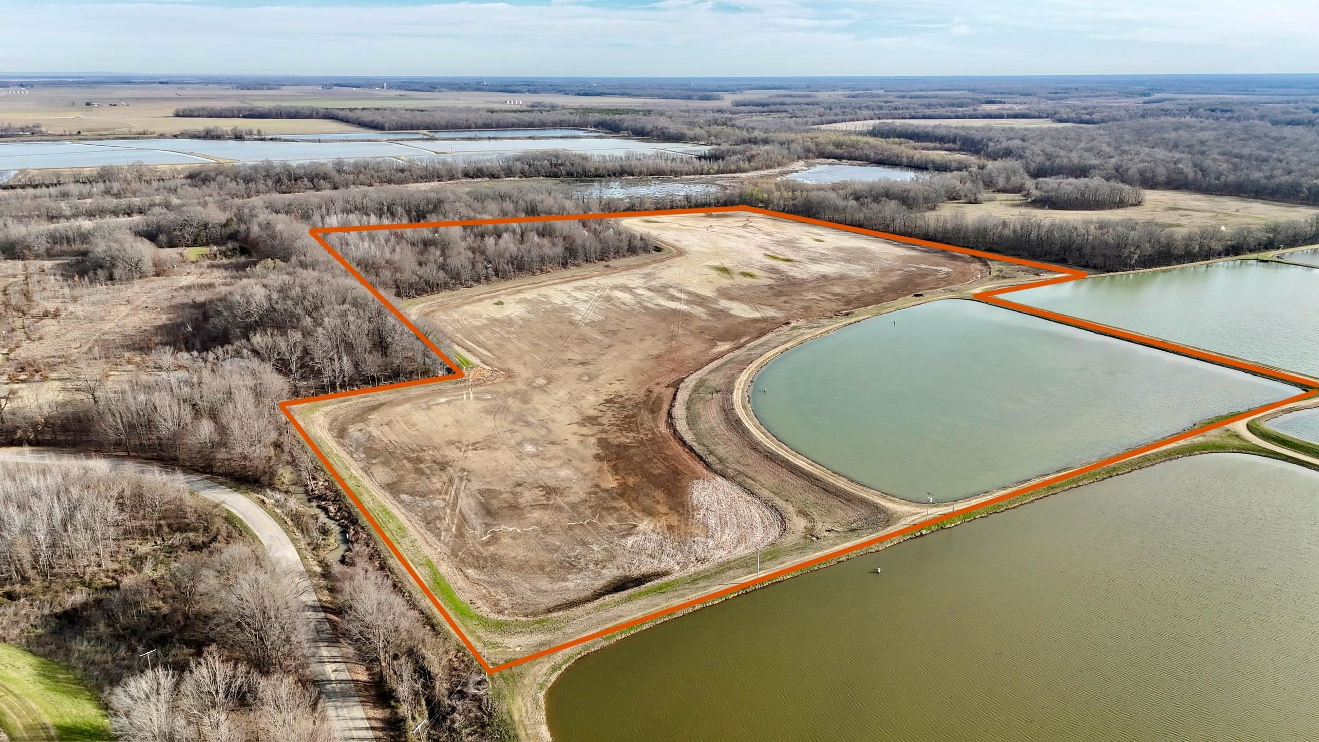Located right off of Big Creek, this 55 acre property, 37.5 acres of which are precision leveled, hunts much bigger than most properties out there. Surface water is the key for duck hunting, and this property is surrounded by 250 acres of minnow ponds to the south, adjacent to a private 60+ acre duck slough to the north, and hundreds of additional acres of fish ponds to the north. Big Creek runs just to the north of the property providing seasonal flooding and a consistent water source to flood the property. The precision leveled acres are ready for an ag rotation, or a duck food plot variety of your choice. Yields will be high in the soils that are rich in organic matter from years of minnow production. This is big buck country too, and there's 17+- acres of high ground on the northwest corner to hunt our large antlered delta whitetail. Right at 45 minutes from Little Rock, and 8 miles from I-40, this property is easy to access.