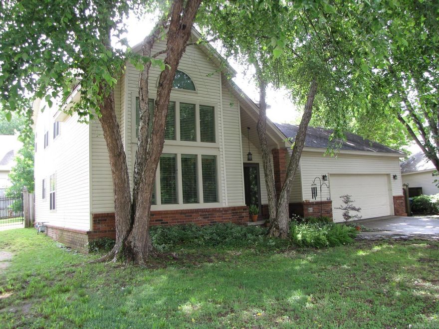 This is no cookie cutter home! Look at this beautiful architectural character. The striking A-frame roofline with a "wall of windows" is a distinctive and eye-catching... that stands out in the neighborhood. The home features a two-car attached oversized garage offers extra space for storage or work space. The dramatic living room makes an unforgettable first impression with its soaring vaulted ceilings and an abundance of natural light pouring through a striking arched transom window and floor-to-ceiling windows. The expansive open floor plan flows seamlessly into the dining area, making it ideal for entertaining. 3 bedrooms and 2.5 baths. Large backyard for relaxing, gardening or entertaining.