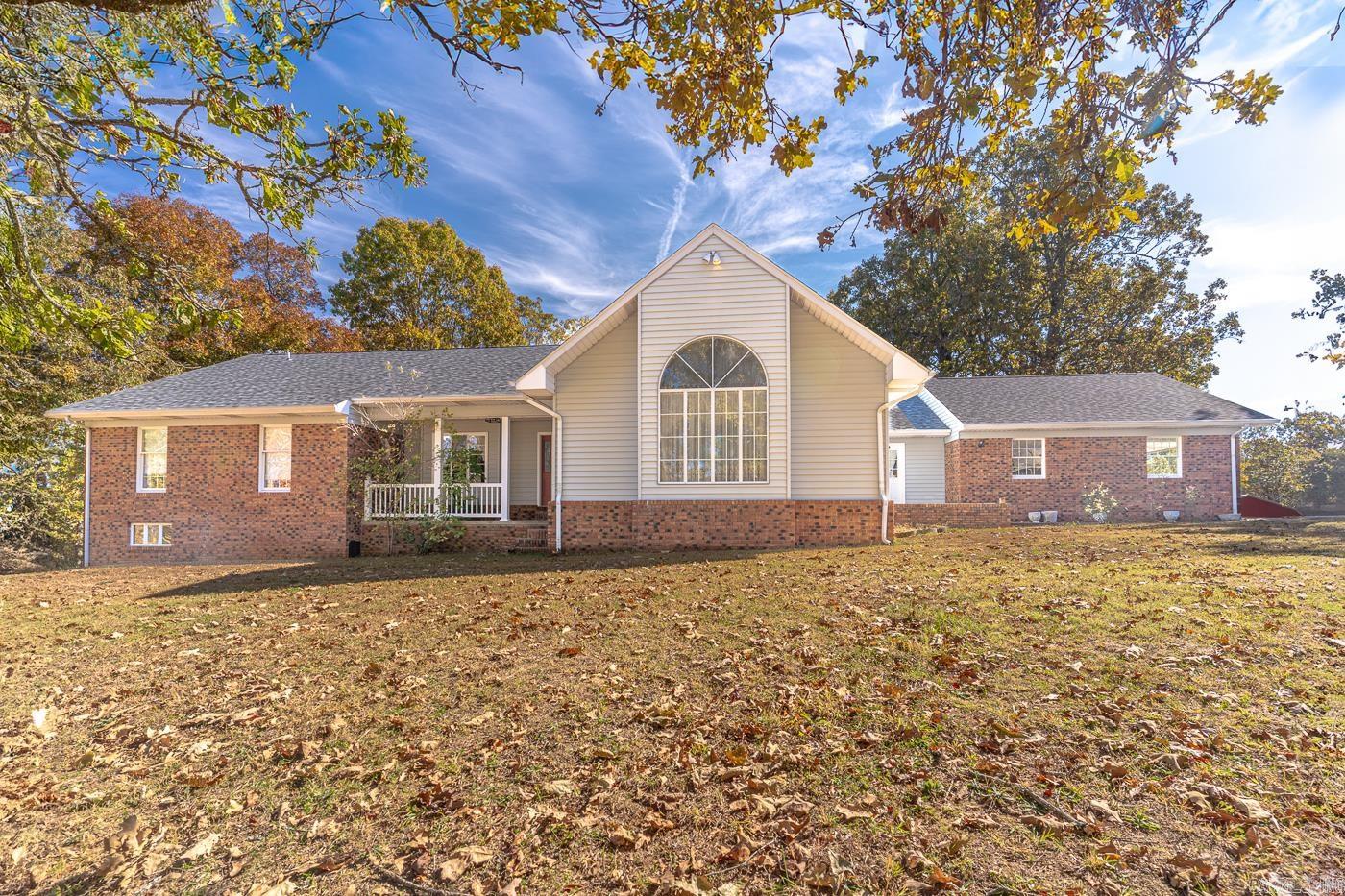 Welcome to Market 347 Hwy 395 North of Salem, AR within Fulton County. Situated on 57 +/- acres w/ river frontage is a 1989 built 4,709 sf Ranch Rambler wrapped in brick & metal siding and topped architectural shingles. On the main is 2,961 sf of well laid out living space that holds an eat-in kitchen w/ island & pantry, formal dining rm, living rm, den, Master bedrm w/ ensuite that holds 2 closets, dual vanity, jet tub, and walk-in shower, 3 guest bedrms, spare bathrm and half bath, laundry rm, and foyer. The walkout basement holds 1,748 sf and includes a workshop rm, craft rm, game rm w/ kitchenette area, 2 bedrms, guest bathrm that doubles as a safe rm, and storage rm. The grounds offer pasture & timberland, river frontage, 44 x 22 shop/garage, 32 x 32 barn, primitive barn, paved circle drives, wide 2 car garage w/ storage rm, fencing, wood deck, and patios. You'll love the natural light from large windows, ample storage, deer that play in the yard, and the tree lined nature views. Recent improvements include deck, roof & condenser. Conveniently located a quarter mile to the hospital & police station. Opportunity knocks! Call today to make this prime piece of property your own.