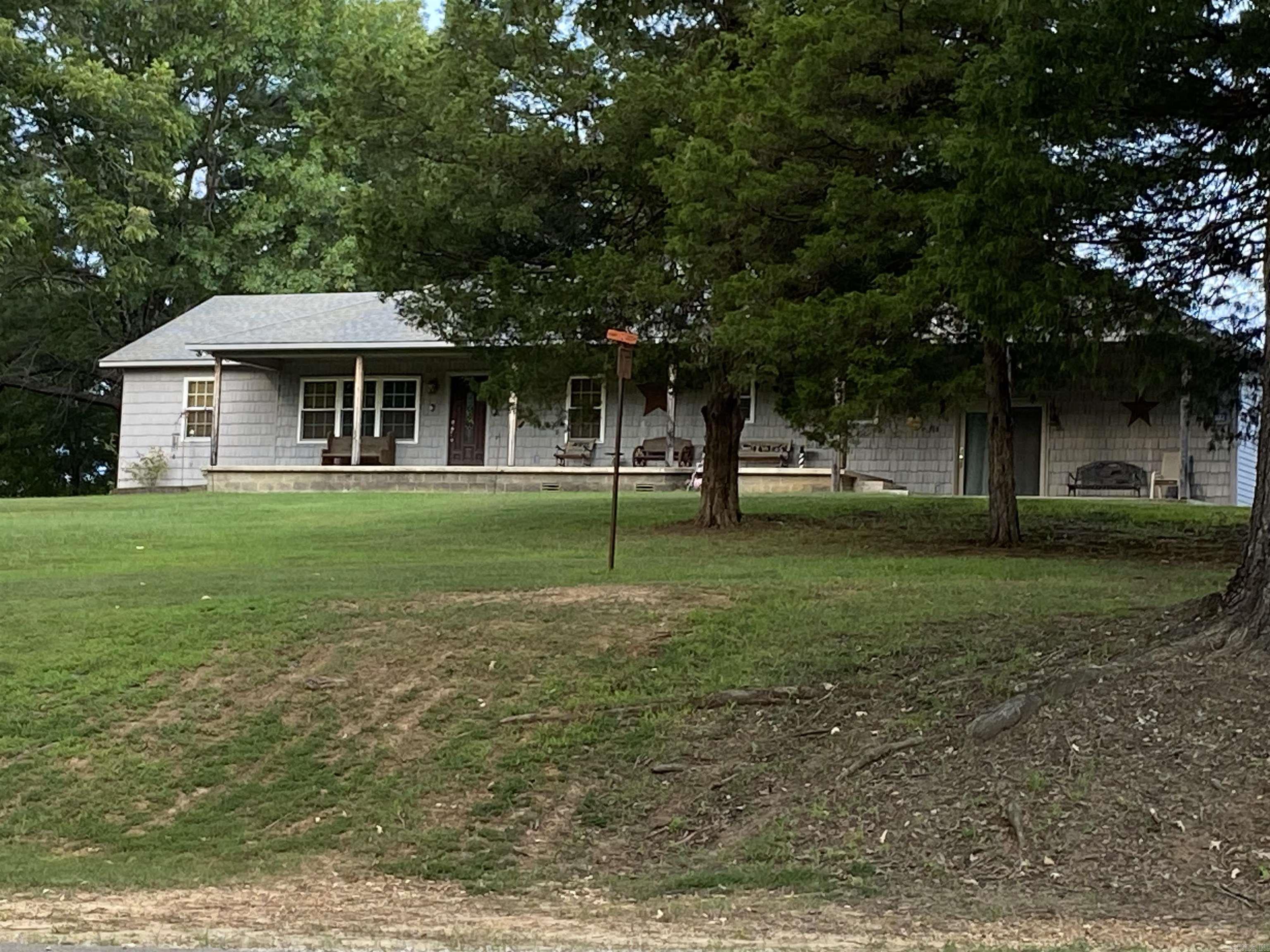 Welcome to this beautiful property sitting near the Greene County/Craighead County line. Situated on 1.96 acres of rolling hills, this house has had many updates in the last few years, including the addition of a beautifully tiled, wheelchair accessible shower. The roof and windows were updated 7 years ago. There are two spacious bedrooms, two bathrooms, and an additional room that could be used for an office or game room! The spacious den steps right out onto the front porch which spans across the front of the house. The three-car garage provides plenty of room to both store items and park. Don't miss the opportunity to enjoy the peaceful, serene countryside from your new front porch!