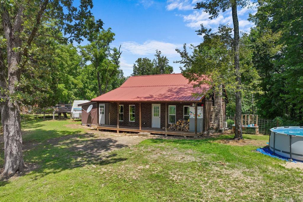 Truly one-of-a-kind! This milled log home is built with square-cut log blocks stacked like bricks, combining rustic charm with solid craftsmanship. The main home offers 1,242 sq ft, not including the heated and cooled addition that provides extra flexible living space. Sitting on approx. 20 acres, the property includes a small spring and creek, perfect for those seeking privacy and a natural setting. Whether youāre looking for a full-time residence, weekend getaway, or future homestead, this property delivers character, durability, and room to roam. Donāt miss the chance to own something truly unique!