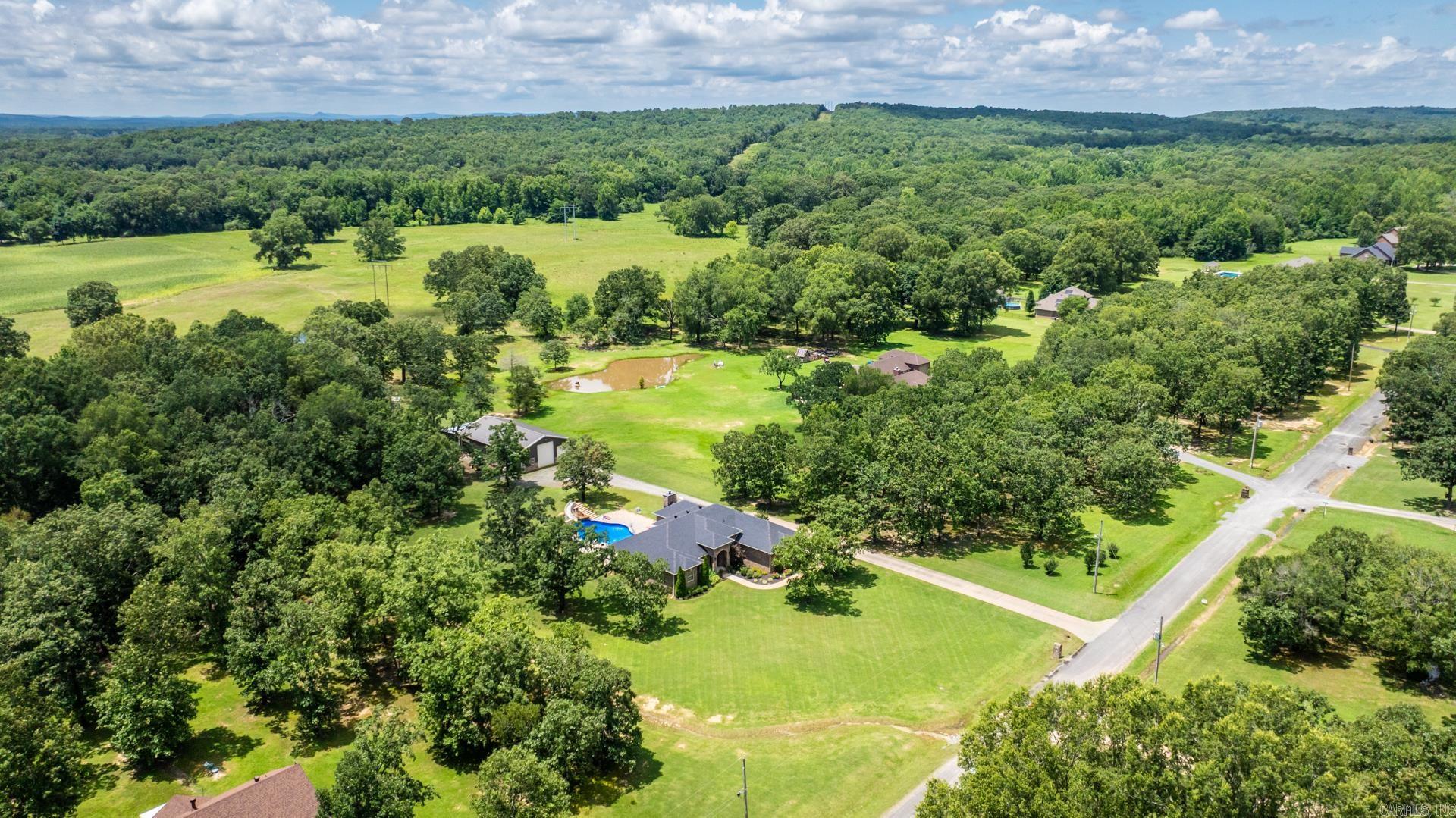 Absolutely beautiful well maintained home.This home has many upgrades and features. Including almost new appliances, HVAC, Pool liner, roof- only 3 years old. Very desireable neighborhood that is convenient but also secluded. Enjoy evenings on a covered back porch overlooking 3 beautiful acres, a huge insulated shop that is aprox. 40 X 60, and a stunning upgraded in- ground pool with a tanning ledge, water feature, and great slide. Garage has a tornado shelter. This home is a rare find and offers something for every member in the family.
