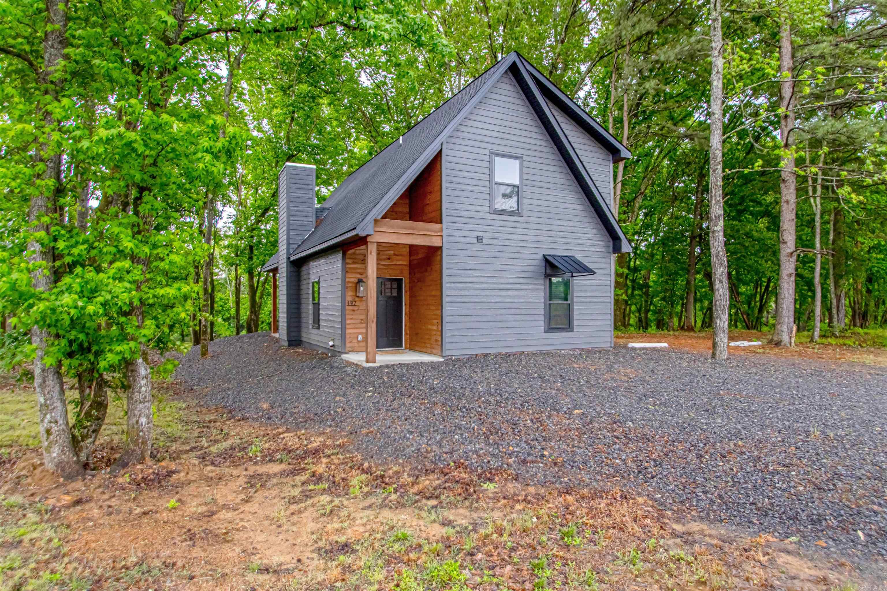 Welcome to “The Onyx,” a brand new, beautifully designed cottage on the banks of the Little Red River, one of Arkansas’s most sought-after trout fishing destinations. Whether you’re seeking a peaceful personal retreat or a high performing short term rental, this turnkey home delivers. Crafted with care and custom finishes, The Onyx offers an open concept layout with a cozy fireplace, floating wood shelves, and sleek quartz countertops. The main level primary suite features a walk in closet and spa style tile shower. Upstairs, a spacious guest room and bonus loft with closet provide flexible space for guests or lounging. You will love the cedar wrapped front porch framed by forest views & relaxing on the covered back deck overlooking the river. Just steps away, enjoy your brand new shared covered dock, perfect for fishing or quiet reflection. Located just minutes from town and a little over an hour from Little Rock, this riverfront gem is a rare blend of nature, comfort, and investment potential.