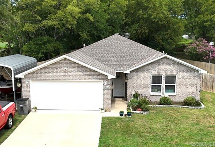 Discover your dream home in this well maintained neighborhood. This 3 bedroom, 2 bath brick home features an inviting layout. The kitchen has modern appliances and a dining area. The primary suite offers a private oasis with an ensuite bath, while 2 additional bedrooms provide ample space for family and guests. Garage and carport for extra parking. Step outside into your privacy fenced backyard. Enjoy your view of your piece of the neighborhood pond. Back patio is perfect for grilling or chilling. Permanent lighting on the home, can change colors for the holidays. Call today to make this lovely home yours.