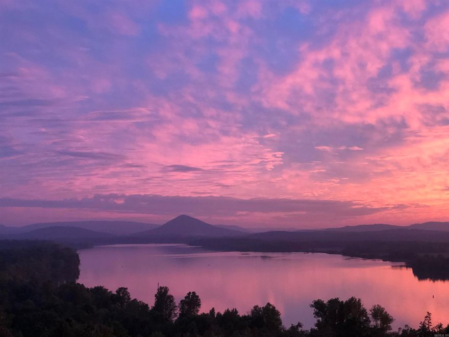 An exceptional lot with views overlooking the Arkansas River and Pinnacle Mountain with some of the most beautiful sunsets Central Ark has to offer!! This stunning property provides the ideal setting for a custom-built home where nature, privacy and breathtaking scenery come together perfectly.  Enjoy panoramic views, peaceful surroundings, and endless opportunities to create your own private retreat. All underground utilities; water, electricity, gas, sewer, ATT high speed fiber. Dwelling minimum 2500 sq. ft.  This property has a back easement for easy access.  Gated for privacy and security. The gate is open Saturday and Sunday 1-4. You're always welcome!