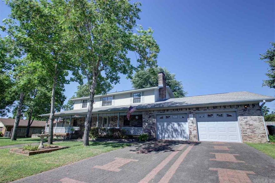 Sits on 2 lots w/fenced in yard. Open foyer, lg living, eat-in kitchen opens to dining w/cozy FP or hearth room, a big utility rm w/sink & extra storage/office space. Plan offers in-law quarter option. Workroom 12 x 18. Beautiful covered porch extends across front of home w/extra landscaping. MBR w/laminate floors. Garage 28 x 21. New full bath down & insulated garage door. 2014: carpet in family room, SS refrigerator, HWH. 2013 Range. 2012 Dishwasher. 2005 Roof RD financing qualifies.  See agent remarks