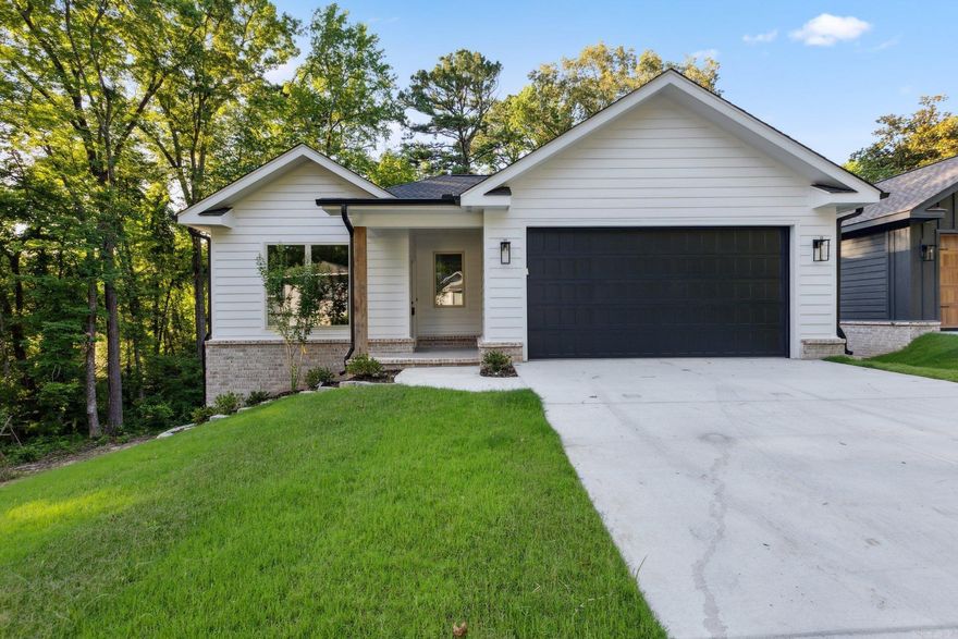 Beautiful 3 bedroom 2 and 1 half bathroom new construction home in downtown Benton!!!  If you are looking for a custom new construction home downtown close to great eating and shopping then look no further. As you pull up to this beautiful home you will love the lot with its great curb appeal and green space in the back yard. Walk in and notice the luxury vinyl floors throughout, beautiful paint colors on the walls and trim, and lots of natural light. The Kitchen has a lot of cabinet space, stainless steel appliance, and elegant granite counter tops. You will appreciate the half bathroom which is convenient  for guests while entertaining. This home offers a large Primary bedroom and bathroom with a stunning full tile shower and granite counters, as well as a large walk in closet. The two guest bedrooms are also large in size with big closets. The guest bedrooms share a Jack and Jill bathroom with a shower tub combo and granite counters. Step out on the back deck overlooking the beautiful back yard that backs up to green space. Hurry and come check out this awesome home that is just a short golf cart ride to all that downtown Benton has to offer.