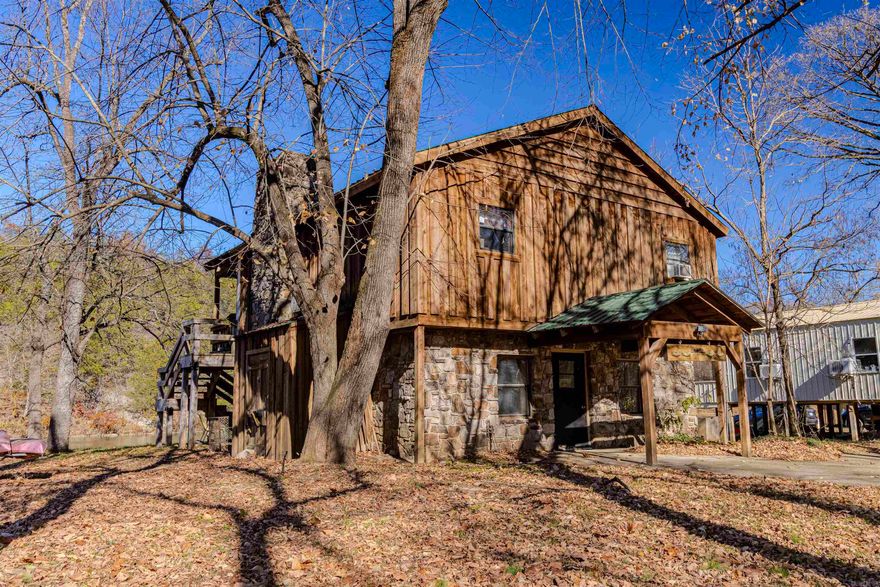 You can't believe the view from the deck of this charming 1546 sq ft 2 story native stone and natural wood cabin directly on the Spring River. Features 2 cozy bedrooms and 1 bath up top with an open living/kitchen area with wood burning fireplace and outstanding waterfall views, plus a lower-level bunk room and full bathroom for extra guests. Enjoy world-class trout fishing, canoeing, and kayaking from your backyard with a beautiful natural waterfall right at the edge of your yard. Also includes large extra lot that could be sold separately. 947 Saddler Falls Rd Mammoth Springs Cozy, well-kept, and perfect as a getaway or rental in a peaceful Ozark river setting. Home is being sold as-is. $359,900 Contact me today for private showing!