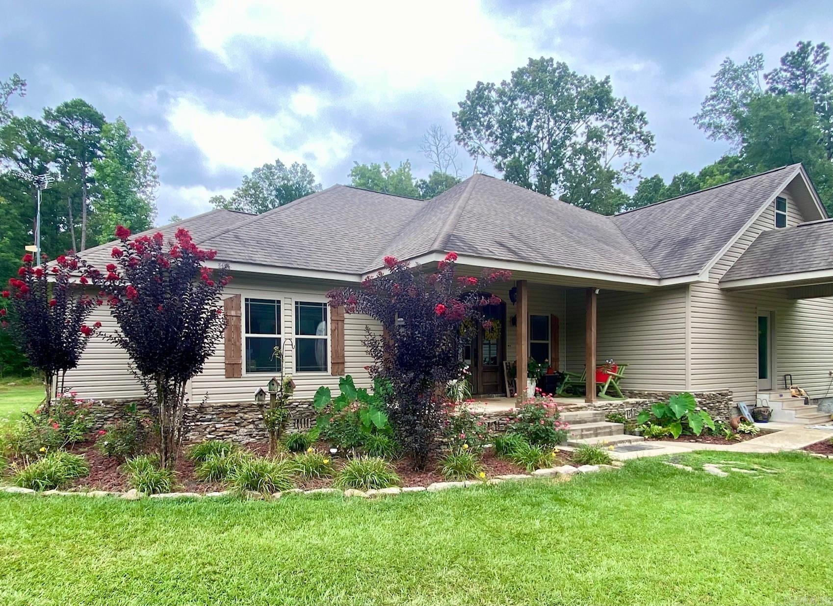 House and 6 acres located approx. 1 mile from City limits and the bypass. Property includes a beautiful pond, raised garden, and   fire pit for your outdoors enjoyment. Interior has 9 ft ceilings, a beautiful stone fireplace, all custom cabinets with granite counter tops. The kitchen has Knotty Alder cabinets, with all the pull outs and extras you could hope for.  All kitchen appliances stay, washer and dryer can stay if wanted. Main bedroom and bathroom has a large walk in closet, custom tile walk in shower, jacuzzi garden tub, double sinks, and a makeup area with extra electric outlets.  This bathroom has it's own water heater for quick hot water that never ends (on demand water heater). There is a study downstairs off the foyer. A half bath and a laundry room off the mudroom. All bedrooms are downstairs and large enough for kings size beds and large furniture. Everyone has their own full bathroom and walk in closet. There is a game room upstairs with a pool table that can stay. Walk in floored attic for extra storage. Landscaping is easy to maintain. Sit on your back porch, or by the firepit, and watch the ducks on the pond, or go fishing in your own back yard.