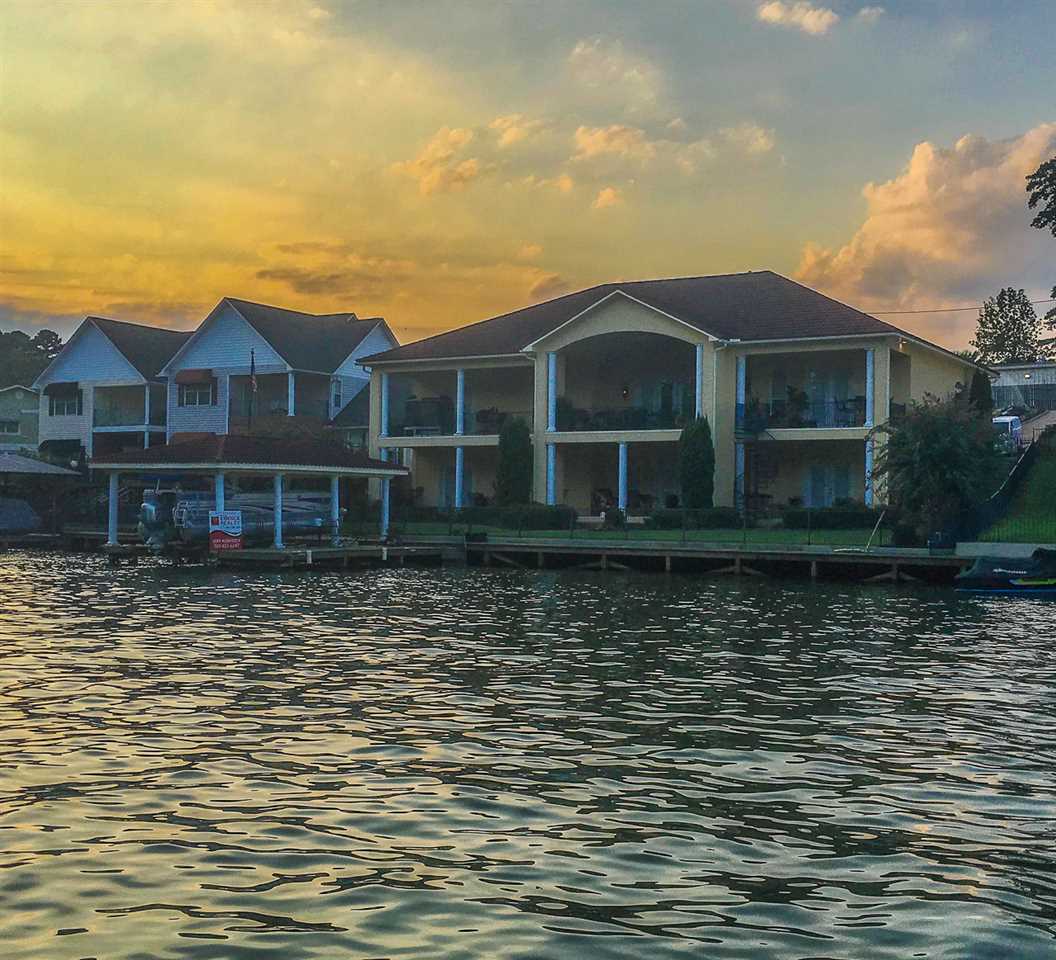 This Mediterranean style estate on Lake Hamilton will capture your heart with its stylish features, sweeping views, city lights and lush enchanting landscaping. The custom designed 4,652 sf two-story beauty boasts superior finishes and is highlighted by walls of glass along the lakeside, along with expansive decks on both levels offering fantastic outdoor living space (there's actually 7,000 sf of living space "under roof" including all of the decks & garage).