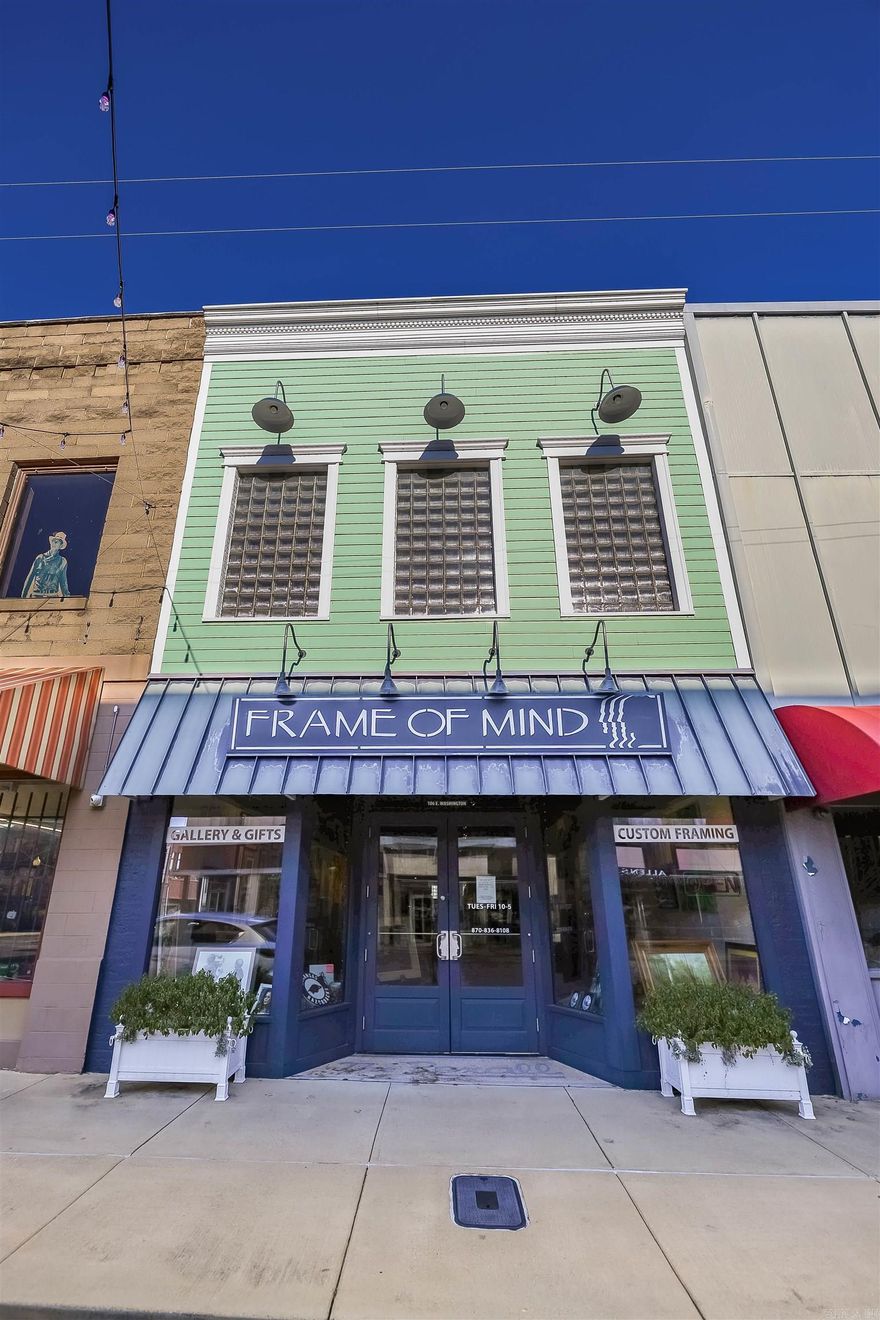 Imagine living in the heart of downtown! With the unique option of over 2,400 sq feet of upper studio living, this historic storefront offers fresh and modern curb appeal with many key updates. Zoning allows upper-story living space for the ideal housing hack -- commercial space on the ground floor to maximize traffic, and livable or rentable housing above!  The open and airy front retail space is perfect for that inviting feel with room in the back with private workspace, office, kitchenette, bathroom, plus access to the additional levels. The versatile upstairs is enhanced with hardwood floors and natural light facing Washington St. If you need more storage, check out the basement with an additional partition and solid slab foundation.   While this unique building is a blank canvas for your vision, there's an opportunity to purchase the inventory and established clientele for framing services. More details provided upon request.
