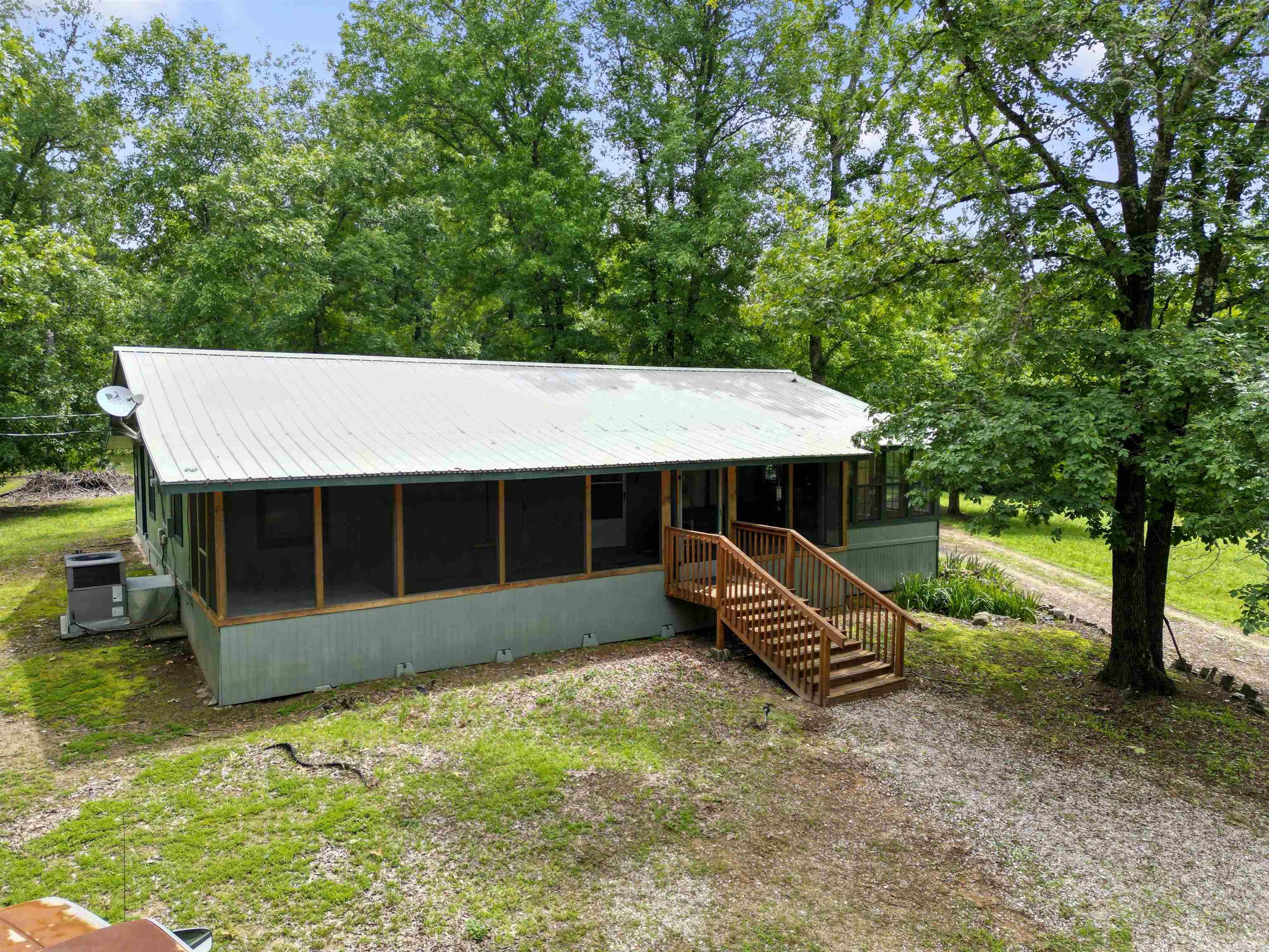 Private Retreat on 4.5 Acres! Tucked away on a quiet gravel road, this peaceful 2-bedroom, 2-bathroom home offers functionality mixed with seclusion. Set on nearly 4.5 acres of beautiful land teeming with wildlife and deer, it's an ideal getaway for nature lovers and hunters alike. A flexible floorplan includes a potential third bedroom with space already prepared for a window and closet, plus a spacious bonus room off the kitchenāperfect for a game room, hunting room, or hobby space. The large kitchen offers abundant countertop and cabinet space, ideal for cooking and entertaining, and opens into a dining area framed by windows that overlook your scenic surroundings. Enjoy peaceful mornings and evenings from the screened-in front porch, where you can relax and take in the quiet beauty of the land. A new metal roof (2021) offers durability and peace of mind, and the home includes a dedicated laundry area for convenience. Whether you're looking for a full-time residence or a private weekend escape, this property delivers space, tranquility, and privacy in a true natural setting. Great for primary residence or even a hunting lodge! Appraisal on file (11/2024). Call today!