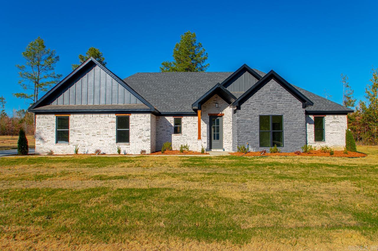 Discover this stunning 4-bedroom, 2-bath home situated on over 2 acres just outside the city limits, offering both privacy and convenience. The open floor plan showcases beautiful custom finishes, creating a warm and welcoming atmosphere. The spacious master suite is your private escape, featuring tray ceilings, a walk-in closet, freestanding tub, and walk-in shower. The living room is the perfect spot to relax, with a striking accent wall, gas fireplace, and wood mantle. Step outside to the extended covered back patio, where you can enjoy peaceful views of the private backyard—ideal for both quiet mornings and entertaining guests. The home also features a side-entry garage for added curb appeal. This home is a must-see for anyone looking to combine style, comfort, and ample space!
