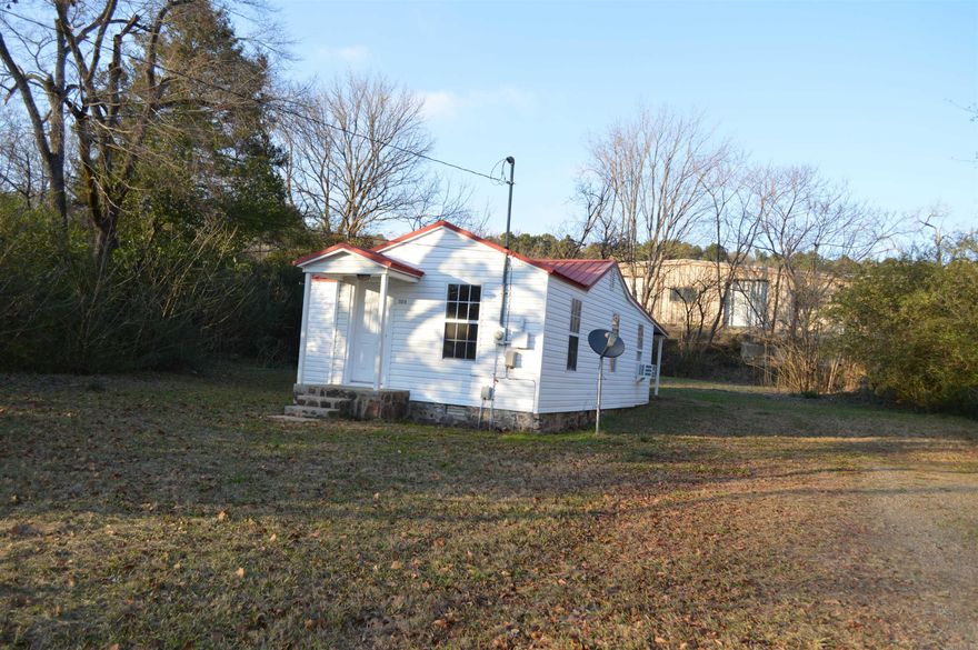 INVESTORS!  This is a newly fixed up doll house.  New windows, new floor coverings, new heat and air window units.  Covered back patio off master bedroom.  Cute as can be.  Priced right.  Large lot.  Great location for walking downtown, Harp's, Dollar General and Library.  Home will not qualify for FHA, RD and VA.  Must be a cash buyer or bank loan.