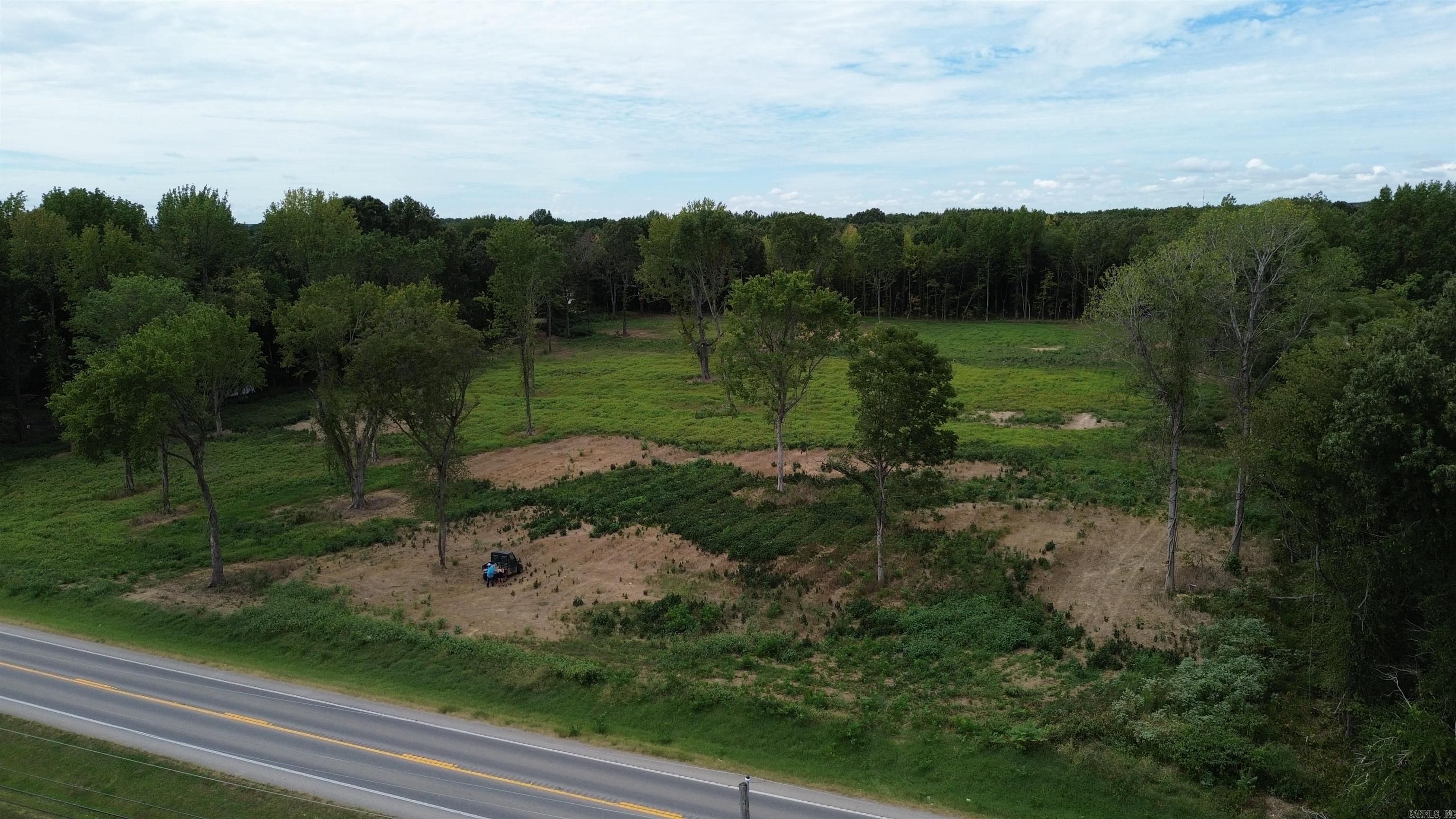 Discover the potential of this stunning 47.61-acre property, where nature meets opportunity. Featuring a lush landscape of mature trees and serene woods, this parcel offers a picturesque setting with ample highway frontage, providing exceptional visibility and access. Whether you envision a private retreat surrounded by natural beauty, a lucrative development project with high exposure, or a mixed-use venture blending residential and commercial elements, this versatile land offers endless possibilities. Embrace the tranquility of the wooded environment while leveraging the strategic location to realize your dreams.