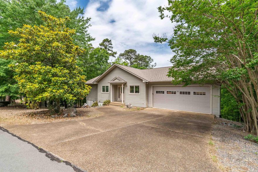 Charming two-level home that offers stunning mountain views and a warm, inviting layout designed for comfort and convenience.  The main level features a spacious primary suite, laundry room, powder room, a separate office ideal for work or hobbies, and a delightful Arkansas room where you can relax and take in the gorgeous scenery.  The living and dining area features rich hardwood flooring, electric fireplace and a vaulted ceiling that enhances the open, airy feel of the space. The lower level provides excellent flexibility with a private second bedroom and full bath, perfect for guests, along with a large workshop that can easily be converted into a third bedroom or additional living area.  Other features include multiple outdoor (covered and uncovered) decks, a two-car garage, and additional storage in the lower-level crawlspace.  Recent updates include a new roof in 2023, a new water heater in 2024, and a newer heat pump (2020), offering peace of mind and added value.  This home blends thoughtful design with beautiful natural surroundings, creating a comfortable retreat with room to grow. Come see all that this home has to offer! Agents see remarks for additional details.