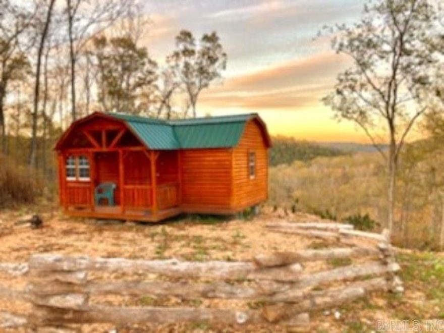 Check out the view on this property! Cozy log cabin on 3.8 acres with an amazing mountain view. New log cabin ready to be made into what you want it to be. There is a split log rail fence at the front of the cabin and a fire pit at the back. Cabin has electric. The property has had the perc test done and has the septic permit. The water tap is at the road. Lick Fork Creek, a wet weather creek, is at the bottom of the property for your family enjoyment. If you are looking for an investment, take a look! This would make a great vacation rental with enough property to add additional cabins, so many options and opportunities.  This can be your forever tiny home or a wonderful place to get away from all the hustle and bustle and just relax and enjoy all that mother nature has to offer in this serene setting.