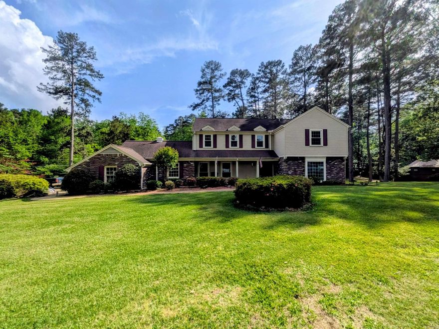 Rare opportunity to own 6 beautiful acres close to the city featuring a stocked pond & attractive custom-built home! A long driveway leads to this spacious home offering a welcoming foyer w/ brick flooring, large living room, & cozy den w/ fireplace & pellet stove. The impressive sunroom at the rear of the home is surrounded by windows overlooking the shaded backyard & pond. Nice eat-in kitchen features neutral granite countertops, stainless appliances (approx. 4 Y/O), abundant cabinets, & 2 pantries. Formal dining room just off kitchen. Upstairs offers 4 BRs, including a primary suite w/ walk-in closet & ensuite bath w/ granite countertops. Hall bath also features double sinks & granite. 3 linen closets & charming window seat in hallway. Double garage includes great storage room w/ pegboard & shelving. Don't miss this attractive property offering privacy, space, & a great location! Curtains & drapes will not convey. Square footage, lot size, and year built is taken from courthouse records.