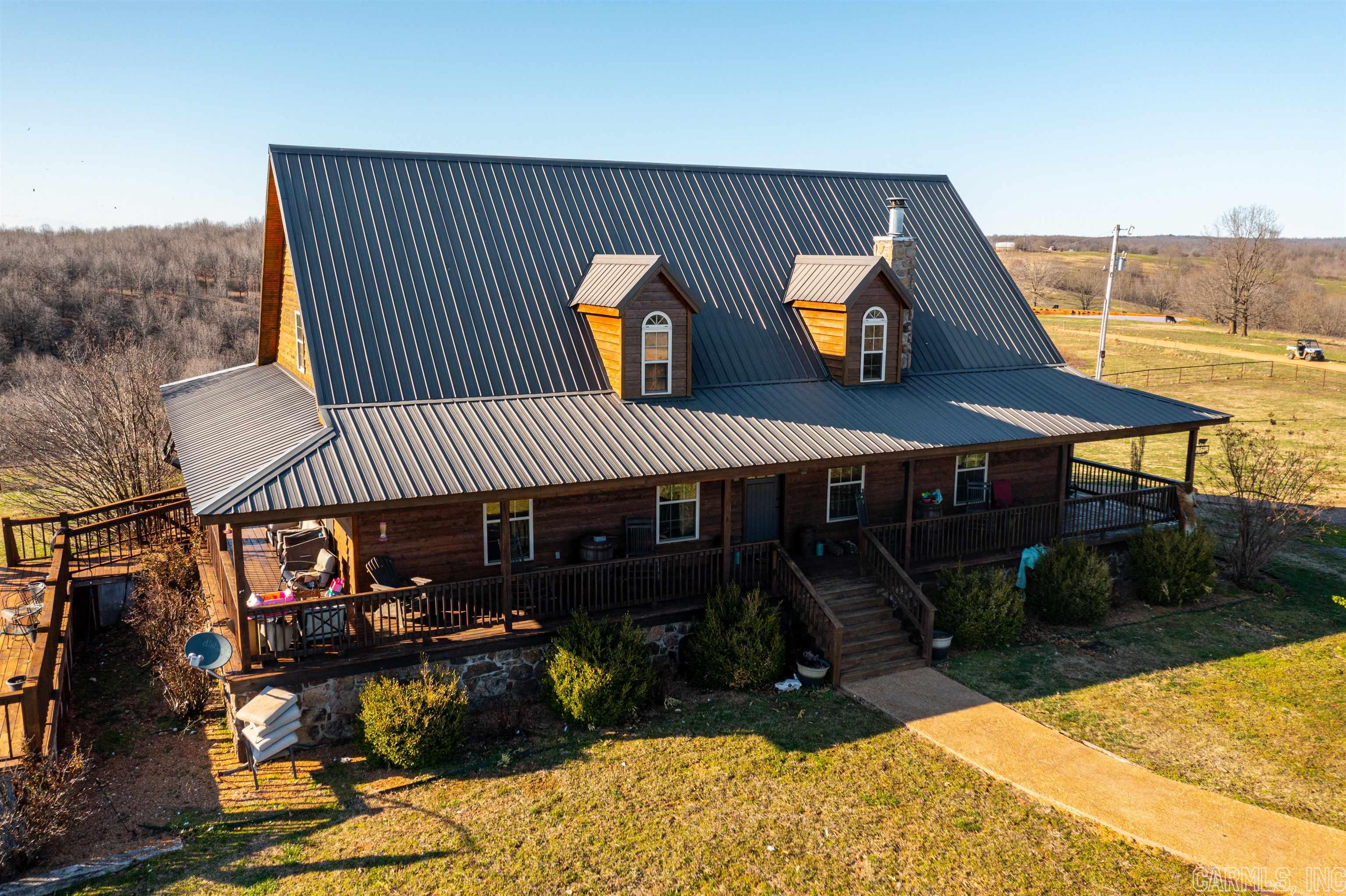 The main house has Western Cedar siding, a wrap-around porch leading down to an above-ground pool with a deck all way around it, a metal roof, and views of the Entire Ranch! Yes, this Western Home sits on the hill overlooking the ranch!When you enter this home, you will see tongue and groove pine on the walls and ceiling. Vaulted ceiling in the living room, dining room, and kitchen.Off to your left are the stairs leading up to a loft area the current owners use as their office.This overlooks the downstairs.Off the kitchen is the laundry room with lots of built-in storage, a sink, a walk-in shower, and a washer and dryer.You will have a bedroom and guest bathroom with a tub/shower in the living room.Off the other side of the living room, you will have the main suite, a soaker tub, a walk-in shower, and lots of storage. Down the stairs, you will have a fully finished basement with a large living room, big enough for a pool table, two bedrooms & another that is used as a bedroom but does not have a window.This is an incredible Cattle Ranch that has so much to offer. I have attached a document that will tell all about this property. PLEASE READ ATTACHED DOCUMENT!!