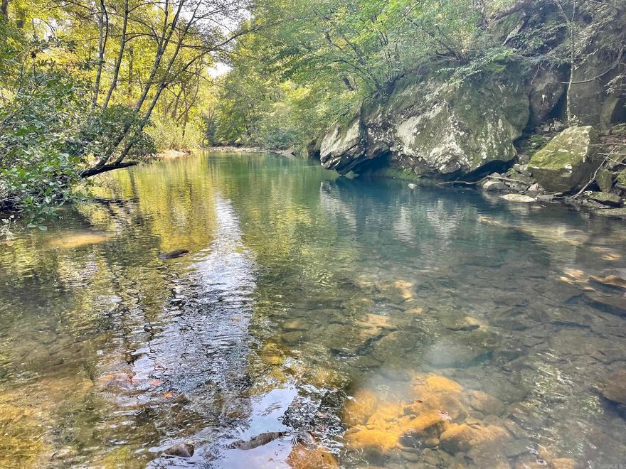 Accessible only by 4x4 vehicle via a U.S. Forest Service road, this extraordinary property is a rare opportunity to own a slice of pristine Arkansas wilderness. The year-round Little Red River flows through the land, its waters carving out stunning rock features, hidden pools, and deep fishing holes brimming with smallmouth bass, bluegill, and other native species. Winding through the property, you’ll discover the quiet stories of an old homestead—stone walls, historic trails, and weathered paths that weave their way through towering old-growth pine and hardwood timber. These trails guide you to breathtaking rock bluffs overlooking the river and a massive natural rock overhang along the banks that feels timeless, inviting you to imagine generations past who may have once found shelter there. Bordering the Ozark National Forest, this land offers unlimited access to thousands of acres of outdoor adventure, including hunting, hiking, horseback riding, and endless exploration. With its combination of rugged beauty, rich history, and untouched natural resources, this property is more than just land—it’s a sanctuary.
