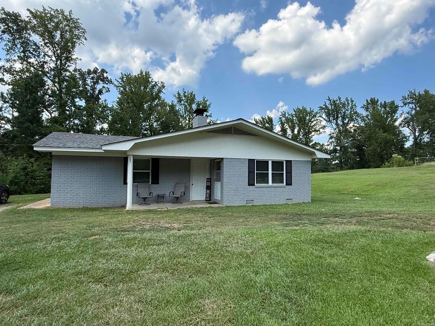 Minutes from Lake Greeson and the Crater of Diamond State Park, this property offers 9.75 acres with highway frontage, pond and brick home with approx 1,950 sq ft of living space.  The home has 3 or 4 bedrooms and 2 baths, large open concept living room with wood burning stove, kitchen with breakfast bar, pantry and dining area.  Covered patio, storage building and old house place offers current storage for hay, with two wells on the property.  Home has newer hot water heater and newer roof, all electric, CH/CA and large laundry room. Contact our office for more details or to schedule a viewing.