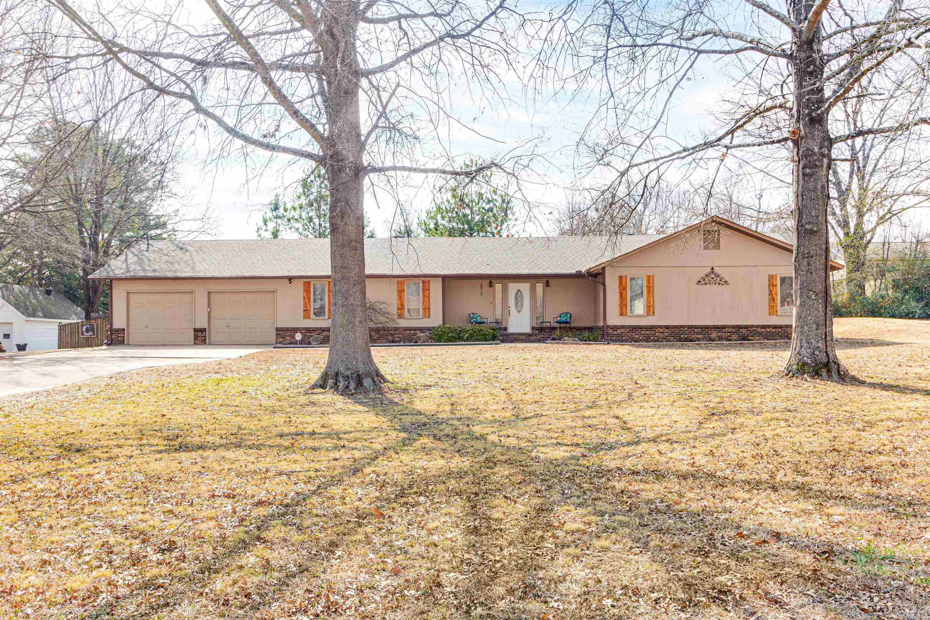 Custom built, two owner home located conveniently in Jonesboro sits on a large lot with mature trees and landscaping. Originally built for the builder, this home has quality finishes throughout plus some hidden ones like 2x6 insulated walls. The oversized living room features vaulted ceilings, wooden beams and a brick wood burning fireplace. The eat-in kitchen has recently been updated with granite countertops, subway tile backsplash, LVP flooring and stainless steel appliances as well as freshly stained custom cabinets with rollout shelves. The main level also features a formal dining room great for entertaining. The primary suite features a custom tile shower, dressing area and an oversized walk-in closet. Off the primary suite is the heated and cooled sunroom perfect for relaxing but would also make a great office. Two large guest bedrooms, one full bathroom with updated vanity and an additional half bath with laundry can be found on the main level. Throughout the main areas of the home is gorgeous hardwood floors. Downstairs you'll find a partial basement that is finished out that is currently set up as a bonus room with pool table.