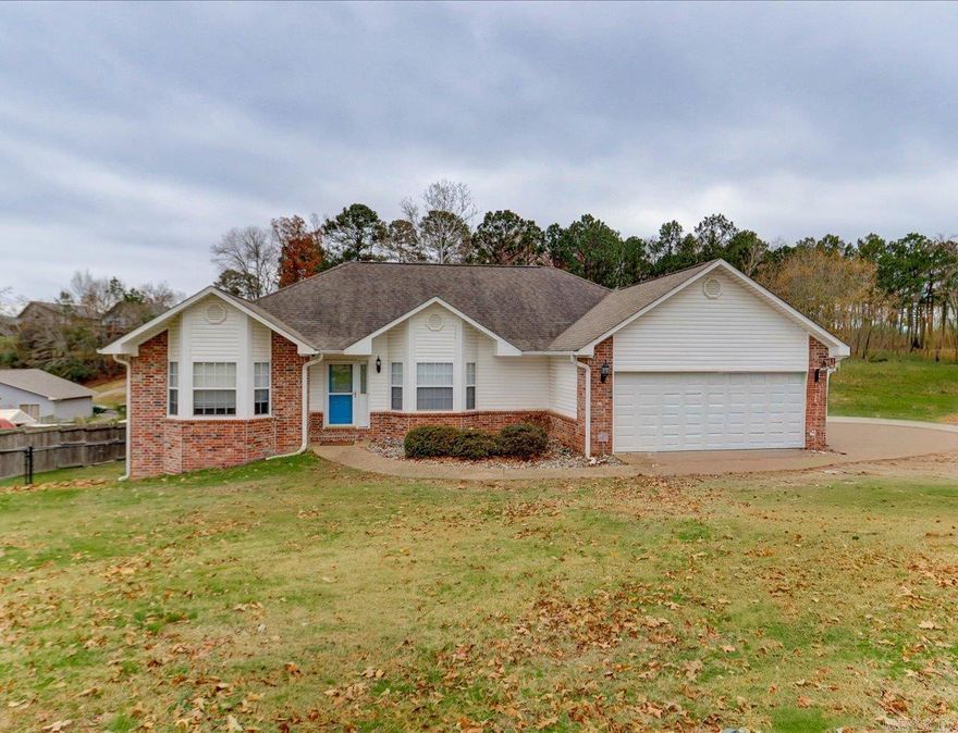 Lake Hamilton living at its best in the Lakeside School District. This beautiful 3-bedroom, 2.5-bath home offers the ease of primarily one-level living, paired with the lifestyle only lakefront can provide.  Enjoy peaceful lake views from the covered deck overlooking Lake Hamilton, just steps from your covered boat dock with lift—perfect for days on the water and relaxed evenings at home. The main level features a private and spacious primary suite with an adjoining office area, along with a well-appointed ensuite bath complete with a jetted tub and walk-in shower.  The lower level adds exceptional flexibility with a heated and cooled bonus space, currently used as a workout room and ideal for a fourth bedroom, office, or recreation area. This level also includes a convenient half bath and is fully incorporated into the home’s total square footage—often referred to as the ultimate man cave.  Additional highlights include a two-car garage, covered carport, and a storage shed to accommodate vehicles, lake toys, and equipment with ease.  A thoughtfully designed home that blends comfort, functionality, and true lakefront living