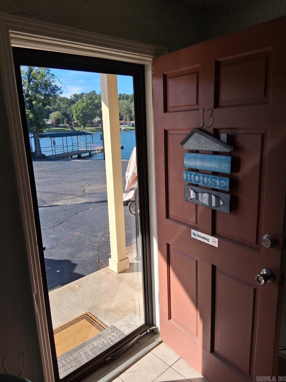Ever dream of having your own Gated Lakefront Condo with your very own covered boat slip? Here is your chance. Act fast! This is the best deal on Lake Hamilton in Hot Springs Arkansas! Unit has had a new pitched roof with ridge vents and new insulation added recently. Views right out to the boat launch and Lake Hamilton from your covered patio. Unit isn't huge, but lives large and feels very welcoming! AND there is a beautiful shared Lodge with Fireplace, large kitchen and dining room w/huge covered patio right on the water that extends your living spaces! Grounds are impeccably maintained, and there is even a beautiful inground pool to lounge by. Comes fully furnished. Ice makers onsite and separate exterior storage unit for lake toys.