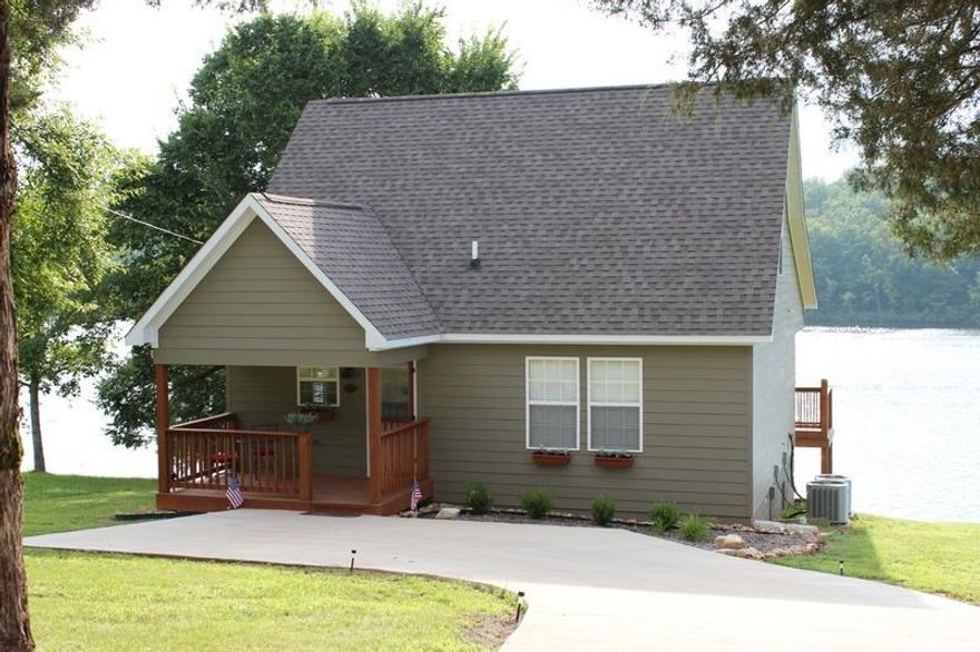 Charming cabin getaway overlooking beautiful Lake Sherwood. The inviting family room features vaulted ceilings, hardwood floors and a fireplace. It opens to the combined kitchen and eating area. This home features two main level bedrooms and an upstairs bedroom with loft area overlooking the family room. This spring-fed lake community offers many activities including skiing, canoeing and kayaking. Additional amenities include city water and sewer, covered front porch and back deck overlooking the lake.