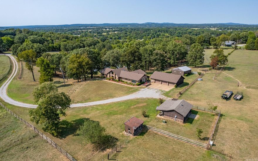 This beautiful house is situated on a stunning 21-acre property with rock siding, two barns, and an unfinished mother-in-law quarters. The house features three bedrooms and an extra room that can be used as a mudroom or man cave. The property boasts a spring-fed pond, perfect for relaxation. It is located just 35 minutes from Fayetteville and 5 minutes from the interstate, offering convenience and easy access to amenities. This is a truly amazing house in a once-in-a-lifetime location. This remarkable property not only offers a comfortable and stylish living space but also provides the opportunity to create cherished memories in a truly exceptional setting. Come take a personal tour today!