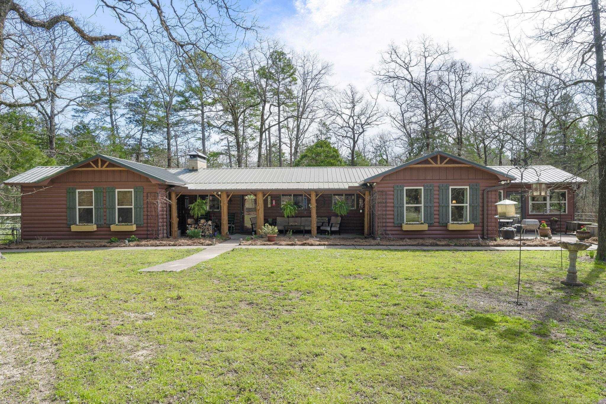 This 251-acre family compound located in Saline County (Lonsdale, AR) offers an idyllic retreat new to the market. Nestled with gated access to the secluded end of Cabin Creek Loop Road, this property boasts scenic river bluff views and pristine river frontage on the South Fork of the Saline River. The lush, level 60 acre pasture is complemented by a permanent hunting and observation stand.150 acres of mature hardwood and pine timber exist throughout the property with several spring fed ponds. Existing trails and roads provide easy accessibility.Ā Wildlife of all types is available on the property including deer, turkey, and bear. The charming custom built 3-4 bedroom lodge-style home is the highlight of the property and is constructed with exceptional quality and features throughout. The horse barn with fenced pasture area is adjacent to the house providing convenient access to horses and pets. Showing is by private appointment only.