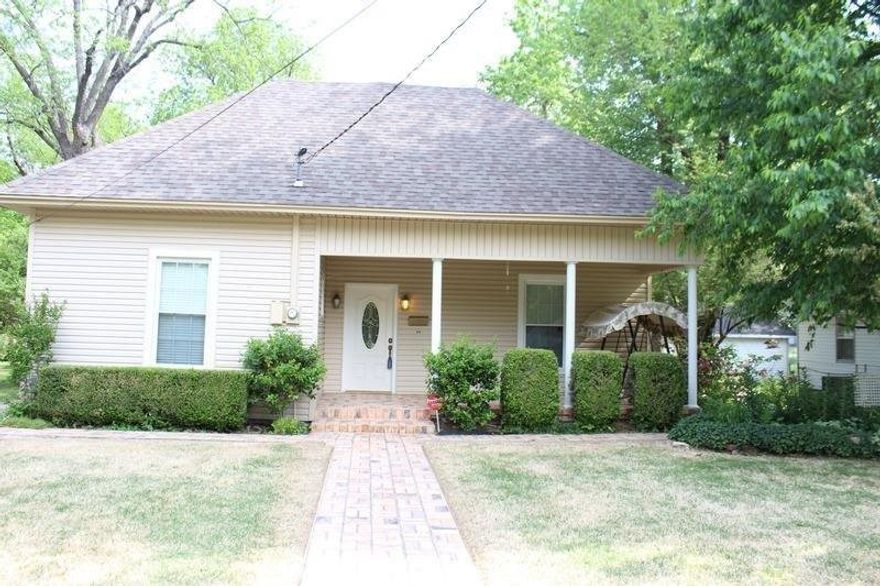 Charming home in the heart of downtown Jonesboro. Inviting family opens up to the lovely dining area. The spacious kitchen features glass front cabinets and a gas range and oven. The two bedrooms offer gorgeous hardwood floors in each. Both bathrooms have been updated with new fixtures. High ceilings throughout give this home an open airy feel. Outside you will find a covered porch, detached garage with extra storage and side carport. You will love this well maintained home!