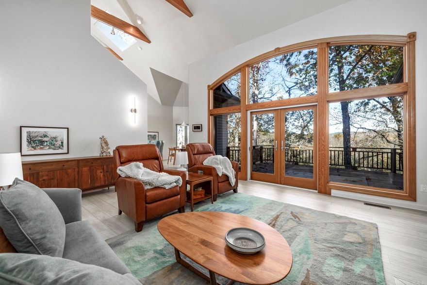 The moment you drive down the long, private driveway and step into this beautifully renovated custom-built home, the views from the great room overlooking the Saline River are breathtaking. This rare gem is situated on a 1.08-acre lot in the desirable Granada neighborhood, providing privacy and convenient access to all amenities in Hot Springs Village. This gorgeous home features an open floor plan with vaulted beam ceilings, a cozy gas log fireplace, complimented by a beautiful, modern kitchen with a breakfast area that showcases the stunning views, perfectly blending indoor comfort with the natural beauty outside. The primary suite offers direct access to a spacious bathroom and a large walk-in closet. Featuring a split floor plan, bedroom three is enhanced by a built-in office area. The large laundry/hobby room connects to the oversized two car garage. The lower level offers a climate-controlled workshop, for hobbies or projects, and an encapsulated crawl space offering ample storage, providing significant utility savings. The upper deck, outdoor patio, and fire pit area are ideal for sitting outside, "listening to the river sing."  This move in ready home is perfect for you!