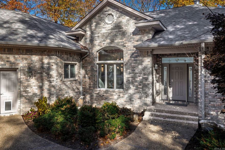 The moment you drive down the long, private driveway and step into this beautifully renovated custom-built home, the views from the great room overlooking the Saline River are breathtaking. This rare gem is situated on a 1.08-acre lot in the desirable Granada neighborhood, providing privacy and convenient access to all amenities in Hot Springs Village. This gorgeous home features an open floor plan with vaulted beam ceilings, a cozy gas log fireplace, complimented by a beautiful, modern kitchen with a breakfast area that showcases the stunning views, perfectly blending indoor comfort with the natural beauty outside. The primary suite offers direct access to a spacious bathroom and a large walk-in closet. Featuring a split floor plan, bedroom three is enhanced by a built-in office area. The large laundry/hobby room connects to the oversized two car garage. The lower level offers a climate-controlled workshop, for hobbies or projects, and an encapsulated crawl space offering ample storage, providing significant utility savings. The upper deck, outdoor patio, and fire pit area are ideal for sitting outside, "listening to the river sing."  This move in ready home is perfect for you!