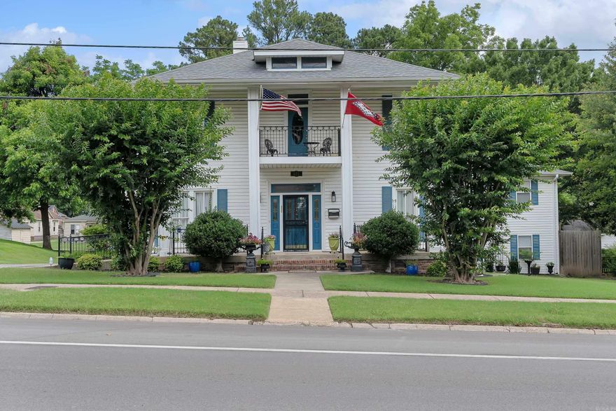 Discover the charm of this meticulously rebuilt Modified Federal Revival home, nestled on the prestigious Crowley's Ridge Scenic Byway and the edge of the Downtown Historic District. This exceptional property, reconstructed 20 years ago with the expertise of an architect, structural engineer, and skilled contractor, offers a blend of historical elegance and modern convenience. The residence boasts a spacious great room with a gas fireplace, a walk-in pantry, and a wine cooler cabinet, enhancing both comfort and sophistication. The heated and cooled cellar and partly floored attic provide ample storage solutions. The oversized 2.5 car garage includes a comprehensive workshop and a delightful garage apartment above, featuring a cozy living area, kitchen, 2 bedrooms, a bathroom with a shower, and modern amenities.  Enjoy outdoor living with a front balcony, a welcoming front porch, and a rear porch/deck. Accessibility is a priority, with 10 parking spaces, including 2 handicap spots with a ramp to the accessible room. Conveniently located with dual parking entrances, this home is a Paragould gem waiting to be discovered.