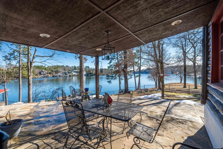 Beautiful views of this Lakefront on Lake Hamilton!! This primitive log cabin cozy hideaway retreat offers 970 sq. ft. of rustic charm, perfectly designed for those seeking a genuine cabin experience with modern comforts. This 2 BR and 1 BR, creates an ideal setting for a weekend getaway or short term rental. The cabin's heart is its inviting wood-burning fireplace, which adds both warmth & character to the living space. Large windows frame spectacular views of Lake Hamilton, allowing natural light to flood the interior while providing year-round scenic vistas. The property's location is a true gem, offering direct access to Lake Hamilton's sparkling waters. Whether you're an early riser catching the morning mist over the lake or a sunset enthusiast enjoying evening colors, this cabin delivers picture-perfect moments throughout the day. The outdoor space has been thoughtfully designed to maximize lake living, making it perfect for both relaxation & entertainment. Conveniently located just minutes from essential amenities, including grocery stores & local attractions. Great potential for both personal enjoyment and investment returns.